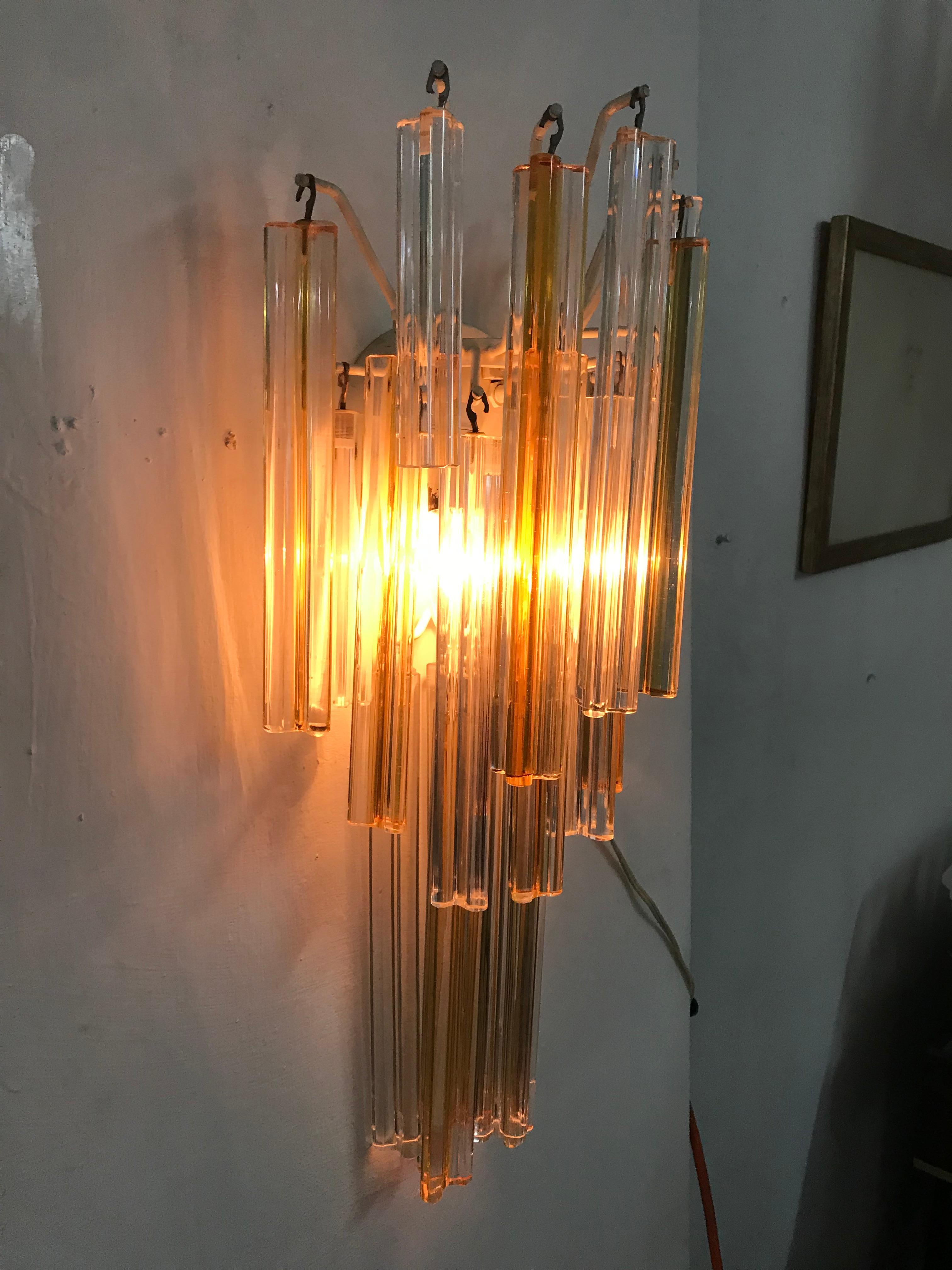 Pair of Mid-Century Modern sconces 'Asta Triedo' model designed by Paolo Venini for Venini and manufactured circa 1960, in three different lenghts of spears in amber and clear colored Murano glass, which can be used to vary the dimensions of each