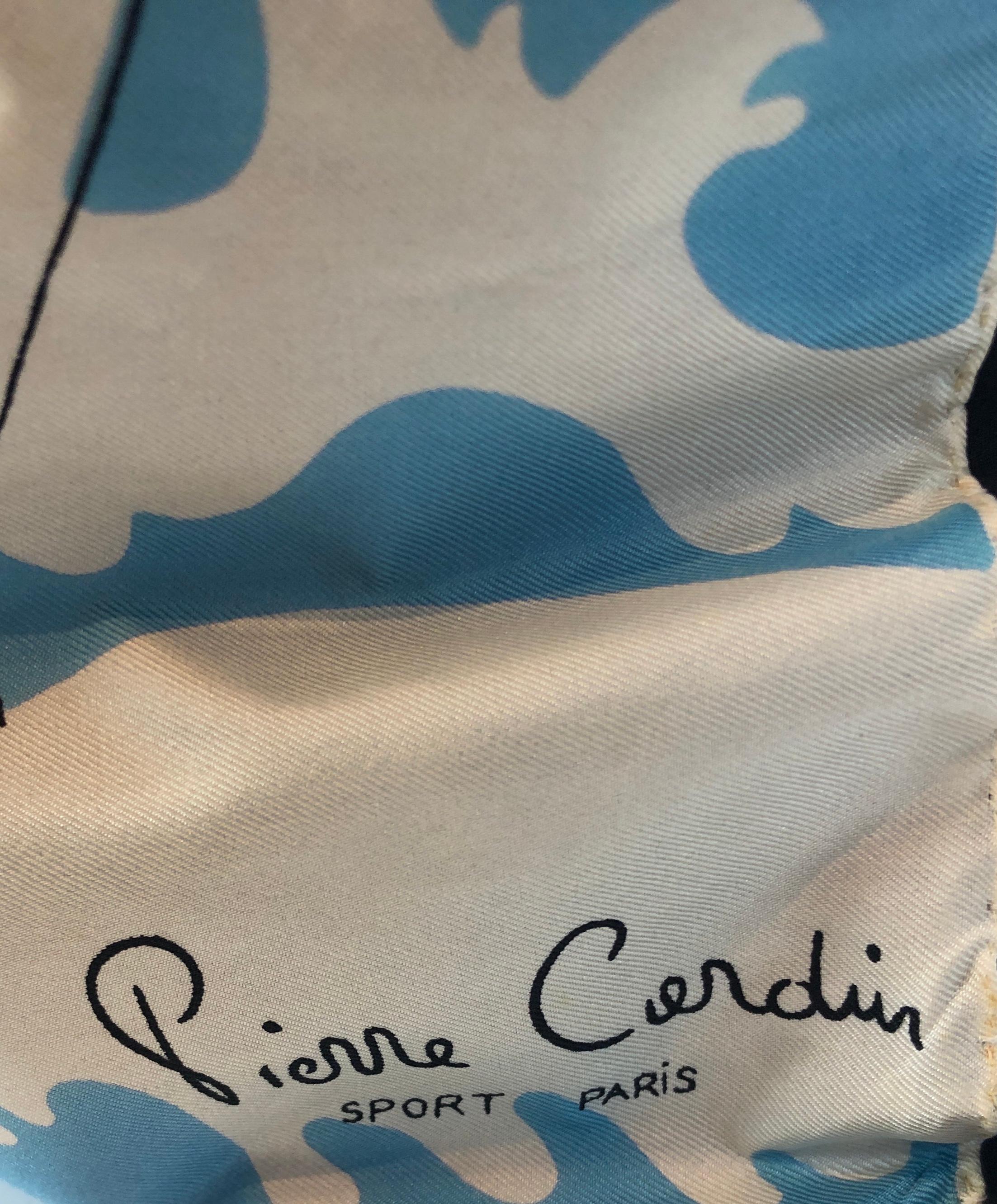 Offered is a Mid-Century Modern retro signed Pierre Cardin silk scarf with black cotton percale backing and poly fill pillow insert decorative pillow. The scarf reflects a modern depiction of early 20th century female swimmers. The light blue, black