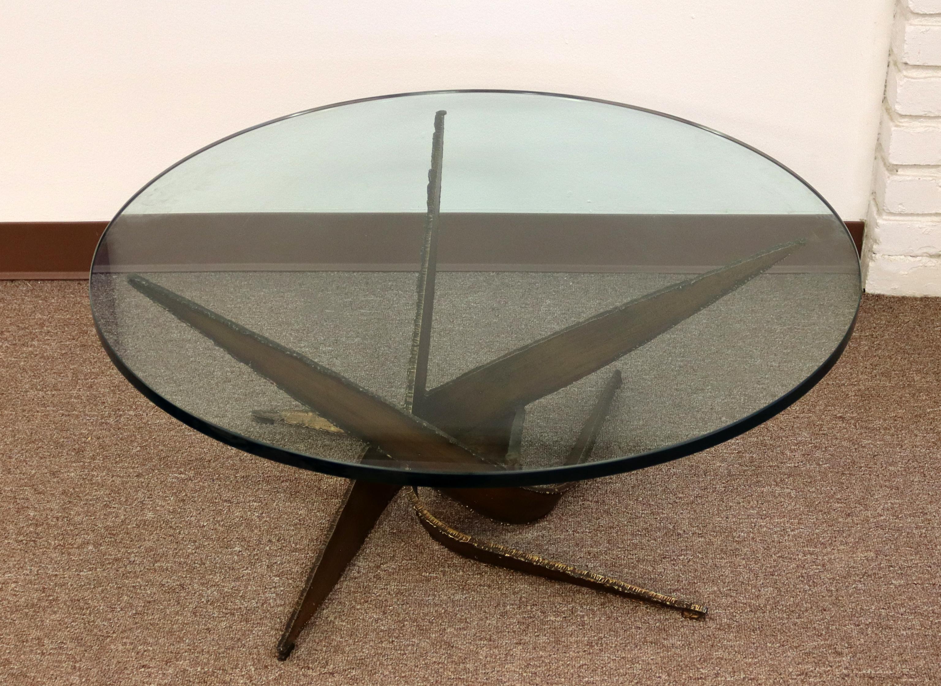 For your consideration is a brilliantly shaped, Brutalist, glass top coffee table, made of bronze, by Silas Seandel, circa the 1970s. In excellent condition. The dimensions are 36