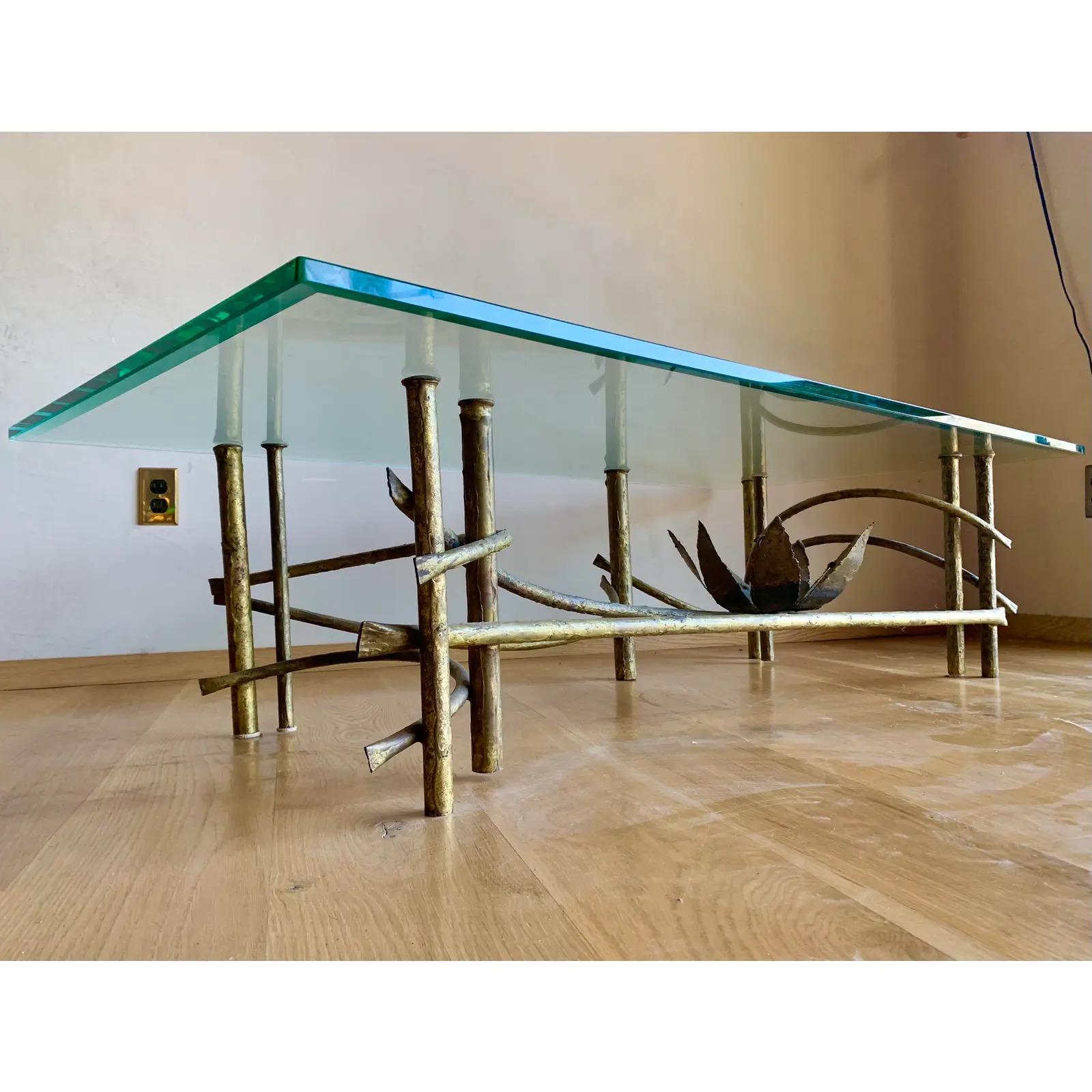 Iconic design piece of mixed metal with gilt finish. Torch cut giant lotus flower blossoms inside a curving, sculptural frame. Both elegant and Brutalist, this piece adds the ideal edge to any space.
Original, heavy beveled high quality glass table