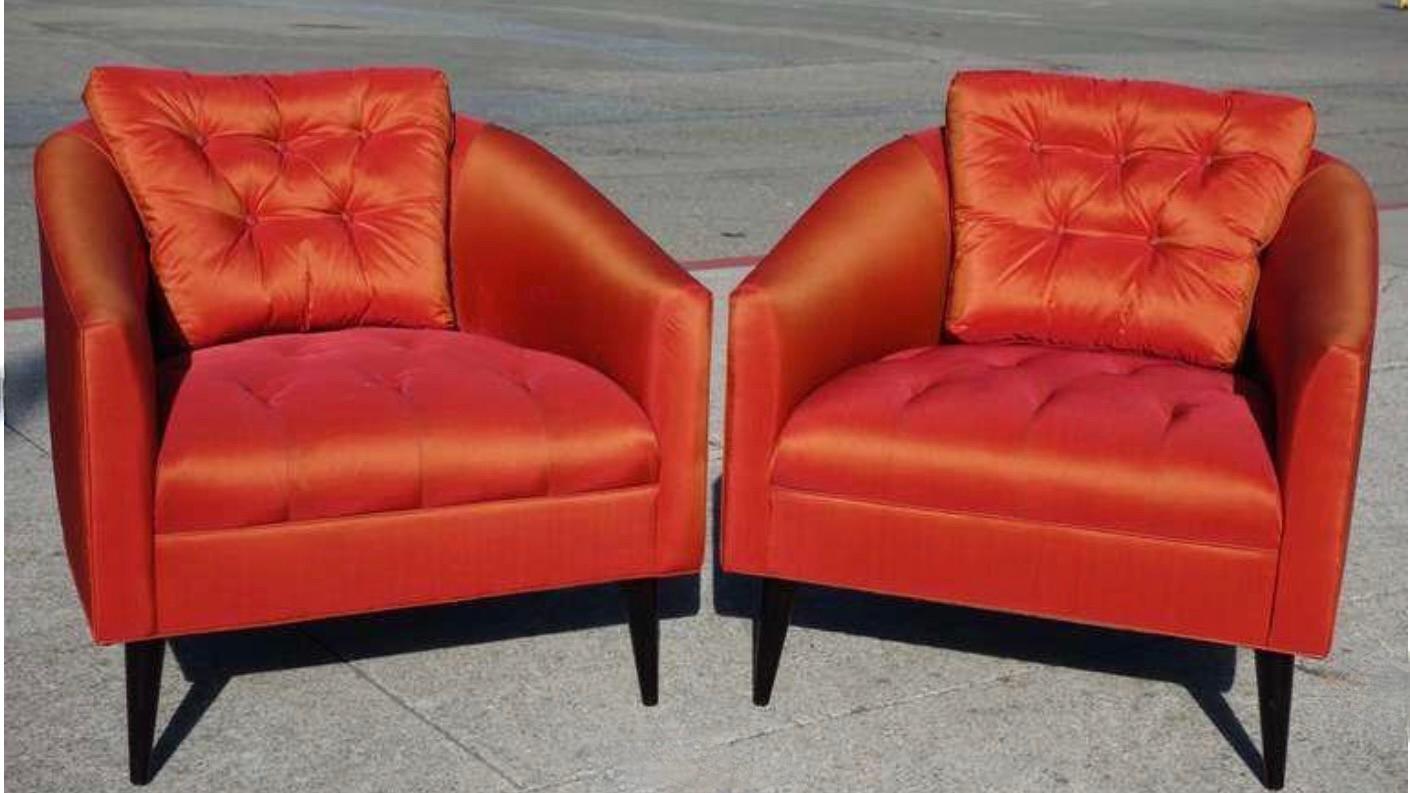 A gorgeous pair of red/orange silk/satin chairs. Beautiful tufting adds the perfect detail to these comfortable chairs. Circa 1950s, United States. Arm height is 20