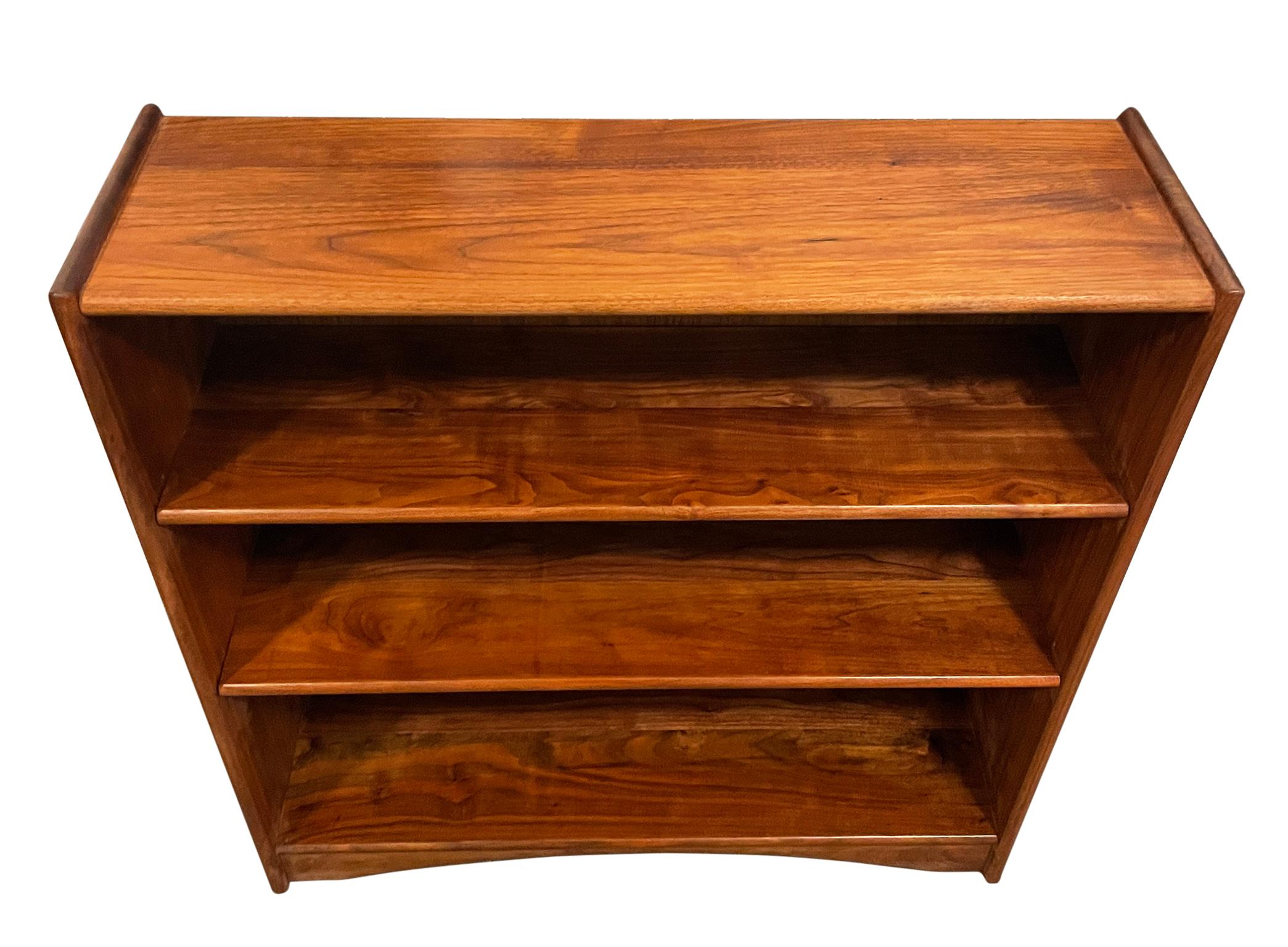 Vintage Mid-Century Modern narrow single bookcase walnut American Studio craft. Beautiful bookcase custom made walnut bookcase, 2 adjustable shelves on pins, Walnut construction and backing bookcase with base good vintage condition. Beautiful grain.