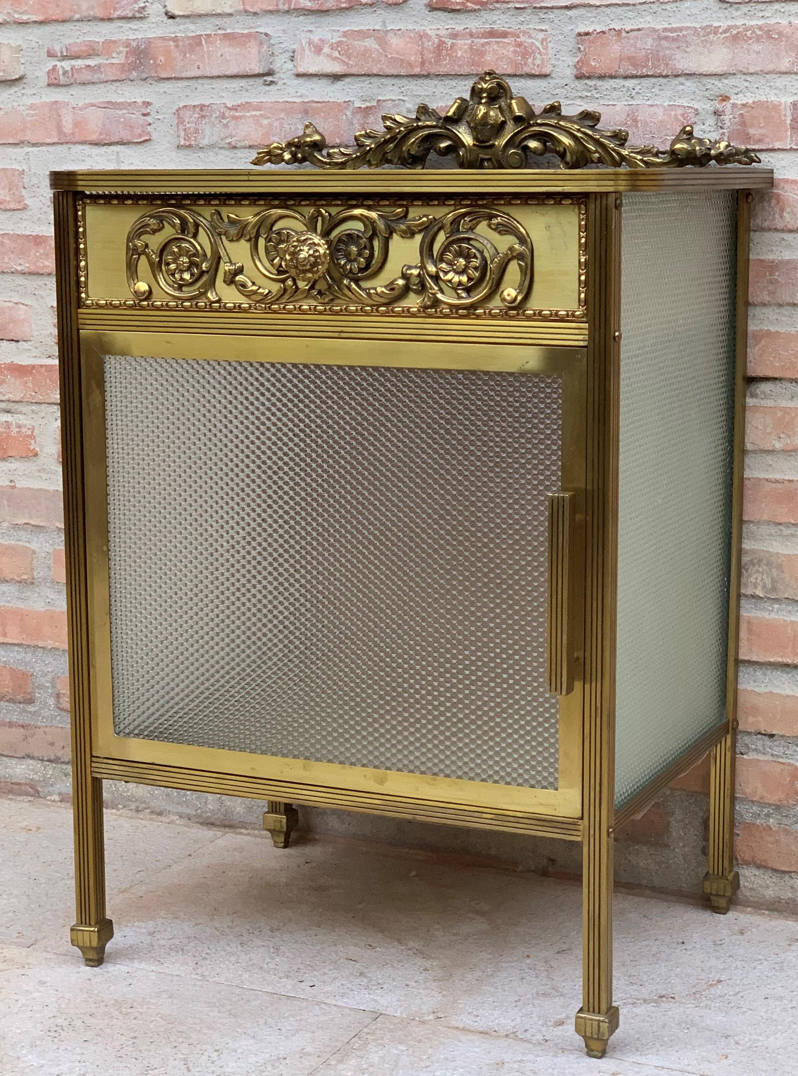 20th century single bronze nightstand with glass door and drawers.

This bronze or glass vitrine cabinet or nightstand is simply stunning and constructed of the finest quality. The bronze mounts of fine form with a single drawer over an open glass
