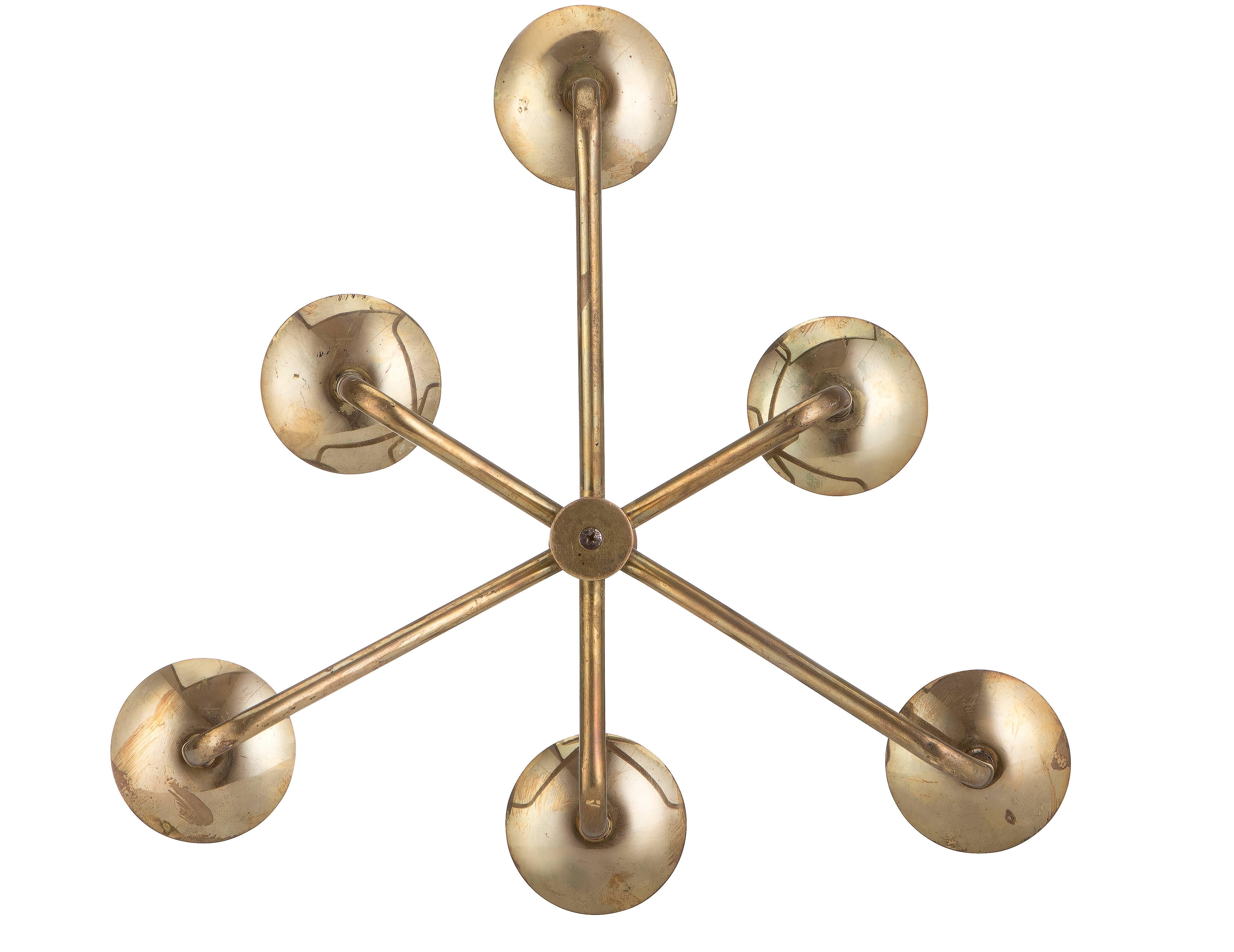 Six-arm brass chandelier in the style of Gaetano Sciolari features an unusual off-set arm pattern. The longer arms measure 18cm from the central column, the shorter arms at 13 cm.
