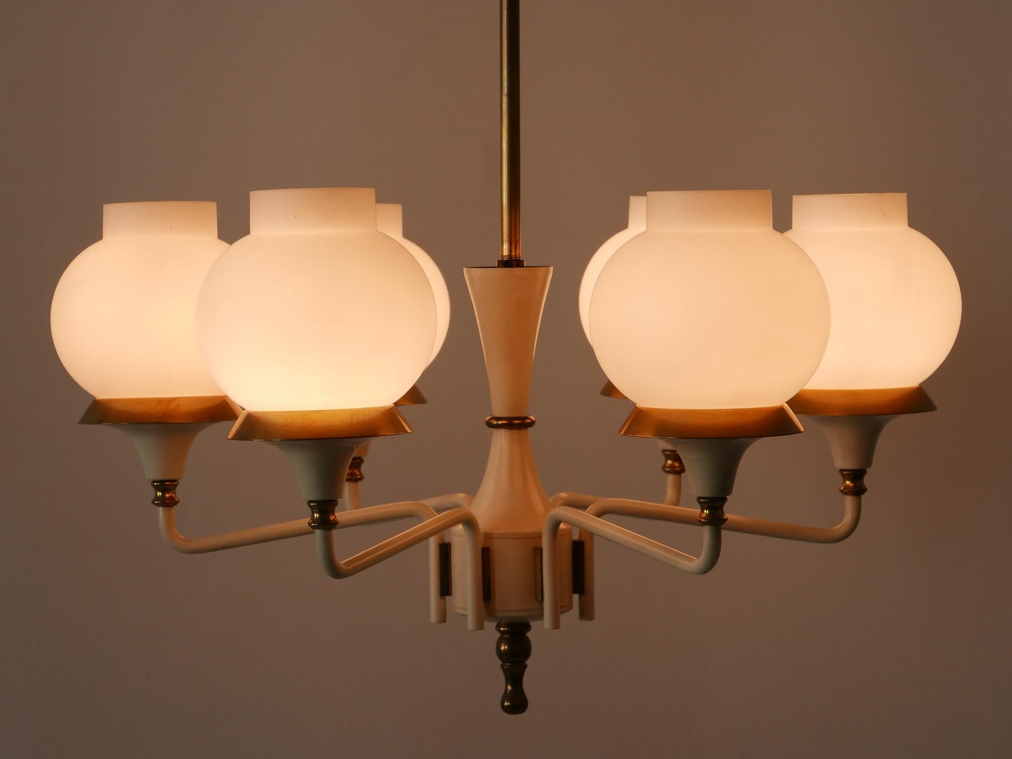 Highly decorative Mid-Century Modern six-armed tulip chandelier or pendant lamp. Designed and manufactured by Kaiser Leuchten, Germany, 1950s.

Executed in brass and opaline glass, the lamp needs 6 x E14 / E12 Edison screw fit bulbs. It is wired,
