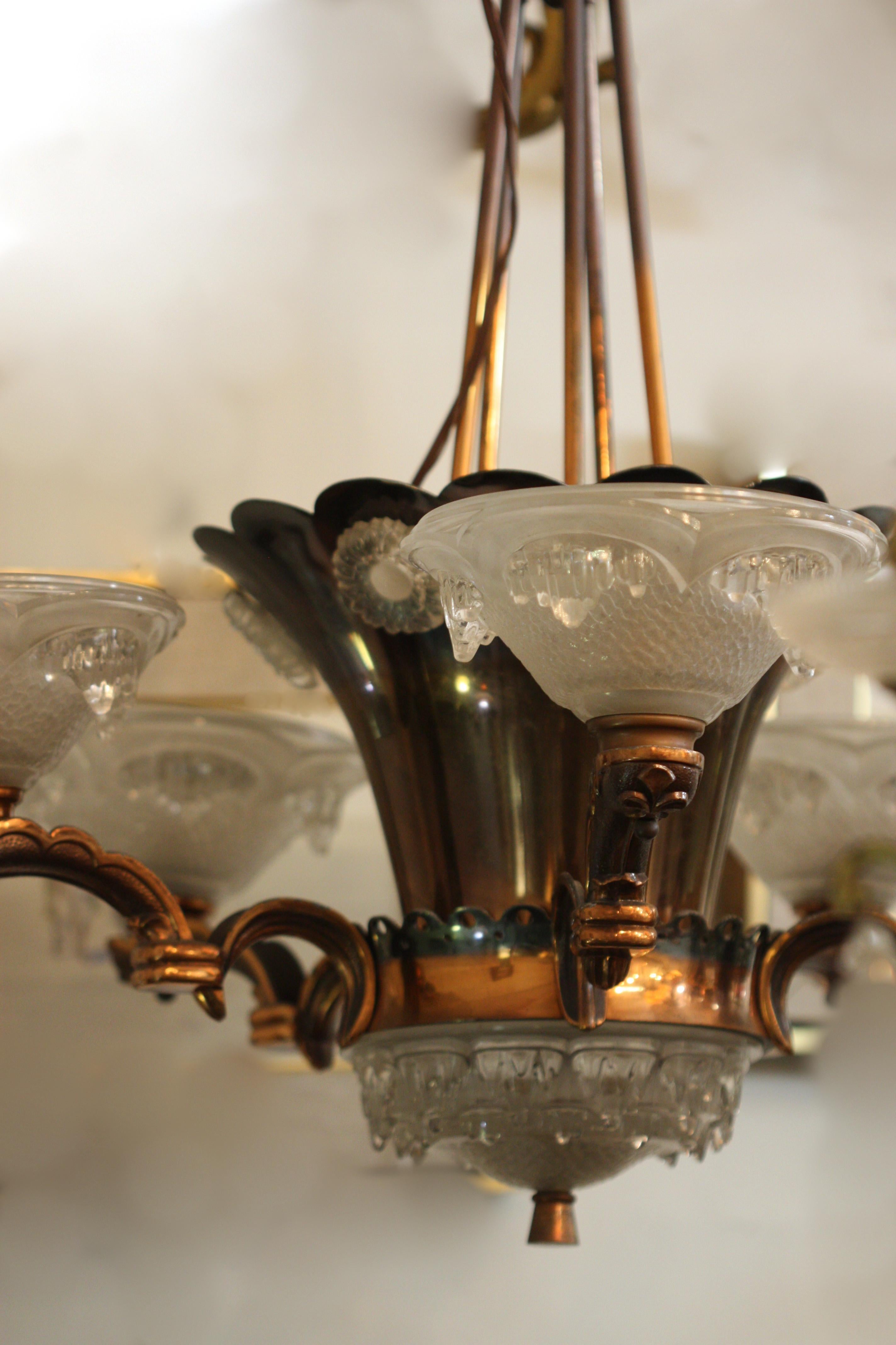 Mid-Century Modern six-light chandelier
1950 - 1959
Original vintage condition.
Chandelier has been rewired.
Dimensions
Height: 37 in. (93.98 cm.)
Diameter: Diameter 29 in. (73.66 cm.)
Shades: Diameter 8 in. 
Materials
Glass, brass,