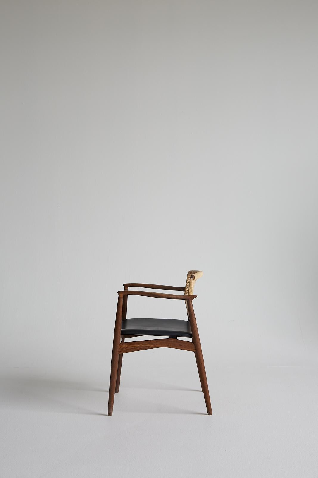 Mid-Century modern SJ.67 Captain chair, cane,  by Erik Buck. New edition

The name gives it away. With its defining armrests, solid seat and supportive backrest, the Captain chair lives up to its prominent calling. It’s an almost underplayed design