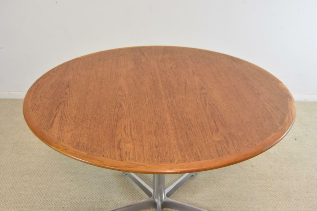 Mid-Century Modern teak and aluminum round adjustable table by Skovmand & Andersen Denmark. Five-arm pedestal base with pieced solid wood banded curved edge. Removable top. Adjustable base. Table adjusts from 19.5