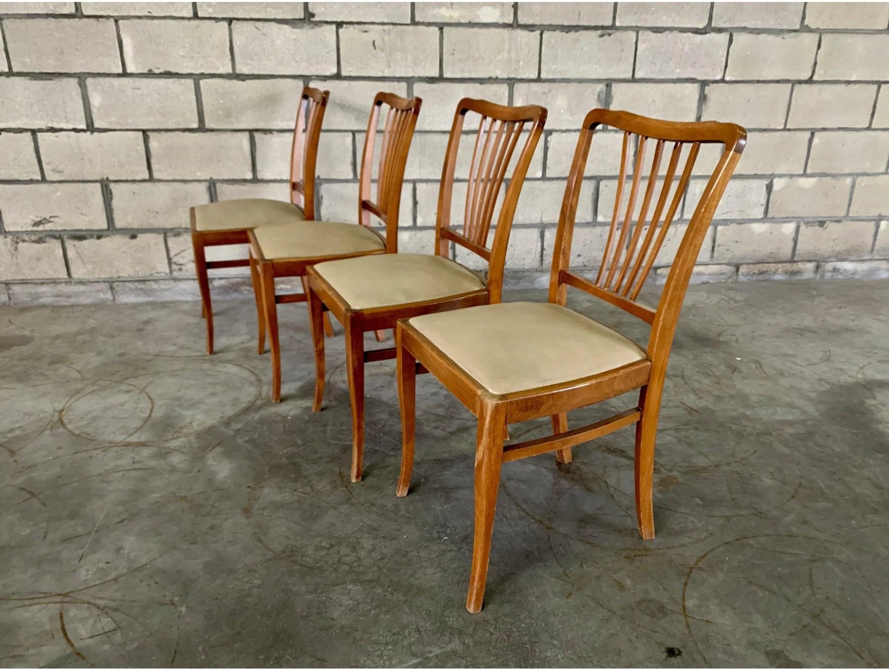 Dimensions: H 33.8” x W 17.3” x D 16.1” x SH 18.5”

Set of 4 Mid Century Modern slat back dining chairs. Upholstered seats in original cream faux leather. This dining chair exhibits a traditional design influence, thanks to its slatted back and soft