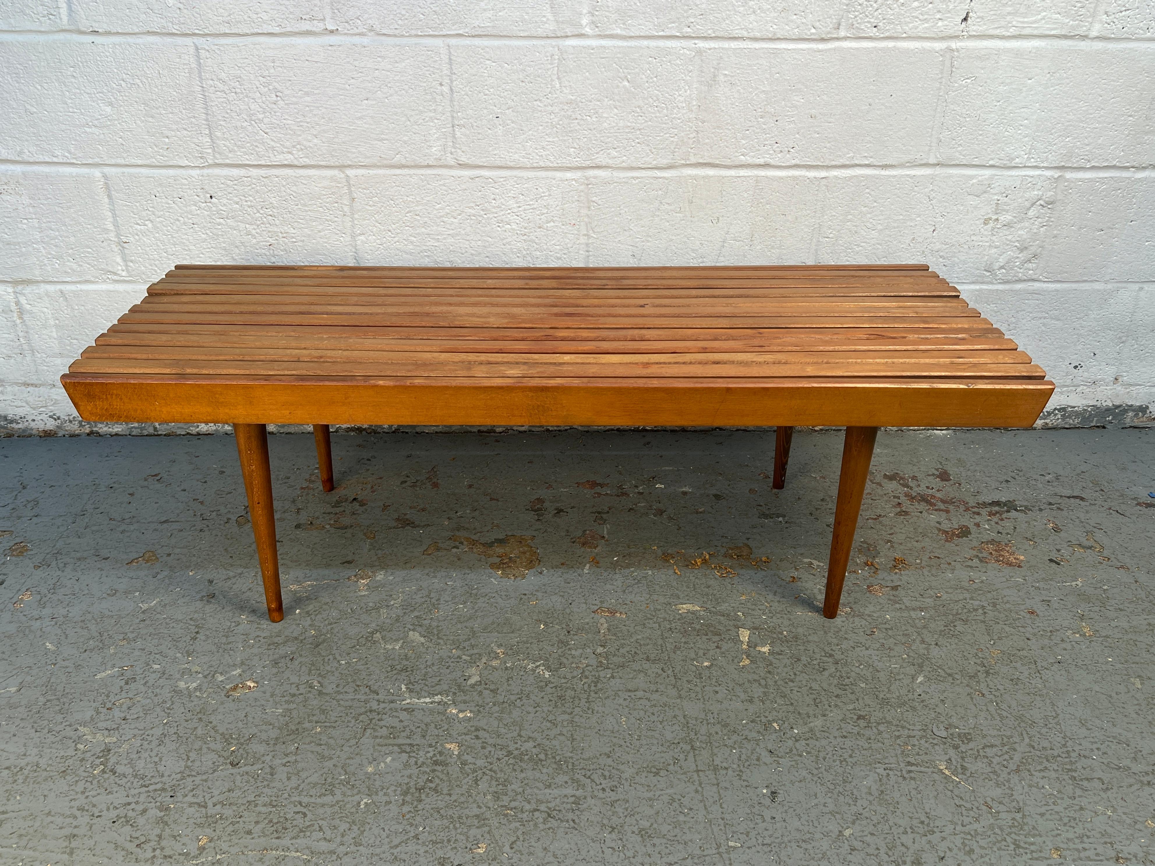 Beautiful mid-century Danish-style slat bench crafted in Yugoslavia before the end of the communist era. The piece features a streamlined form with precise joinery and warm wood tones, embodying the minimalist aesthetic of Scandinavian design. A