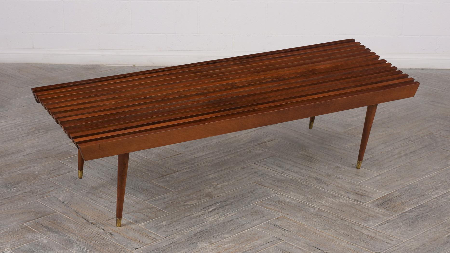 Mid-Century Modern slat bench is stained a rich walnut color and has a elegant patinated finish, circa 1960s. Sophisticated but simple architectural structure which can easily fit in an inside or outside space.