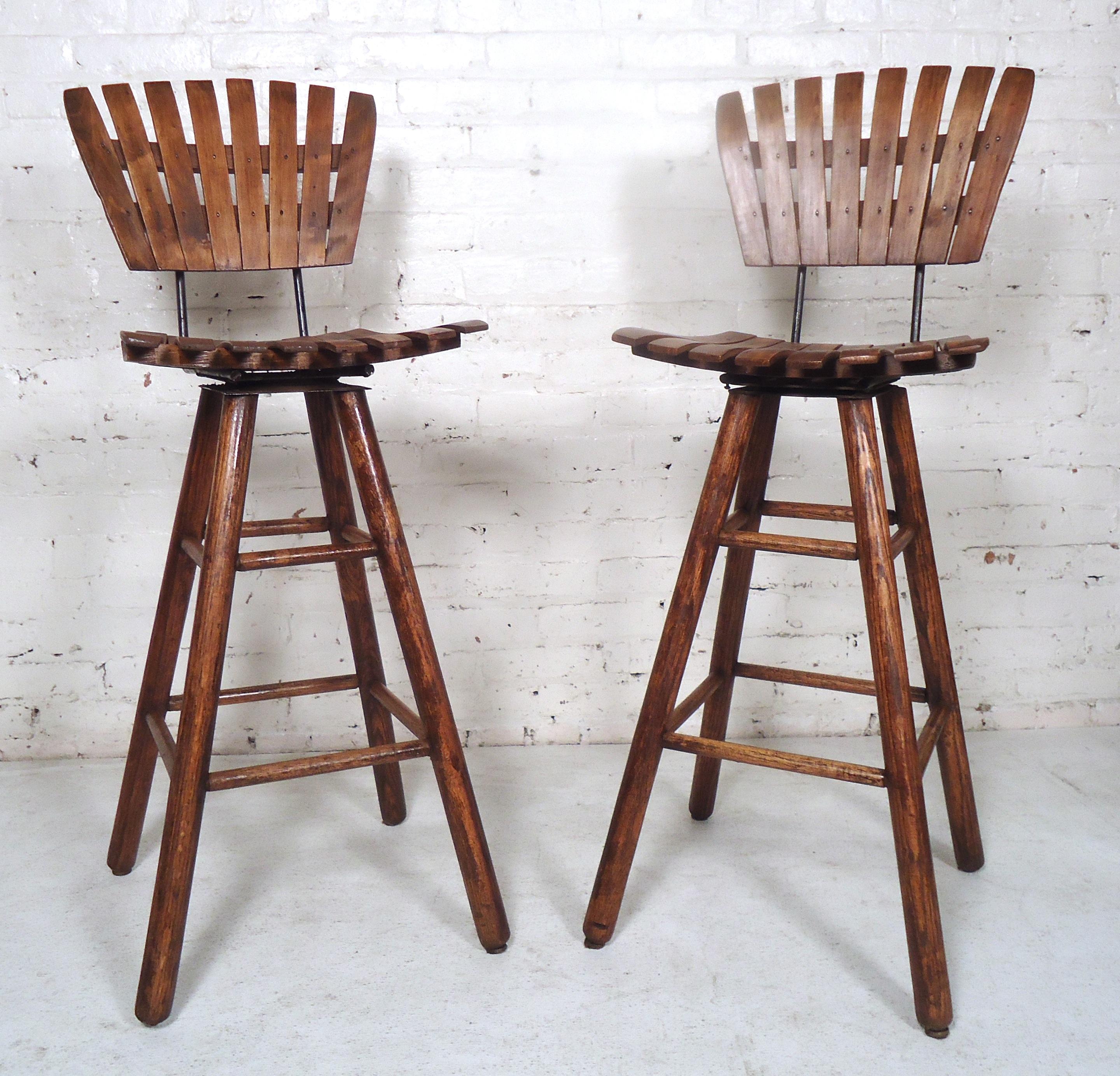 Pair of vintage modern slat stools tall and comfortable design perfect for kitchen use features and iron frame with sturdy wooden legs.

(Please confirm item location - NY or NJ - with dealer).
 