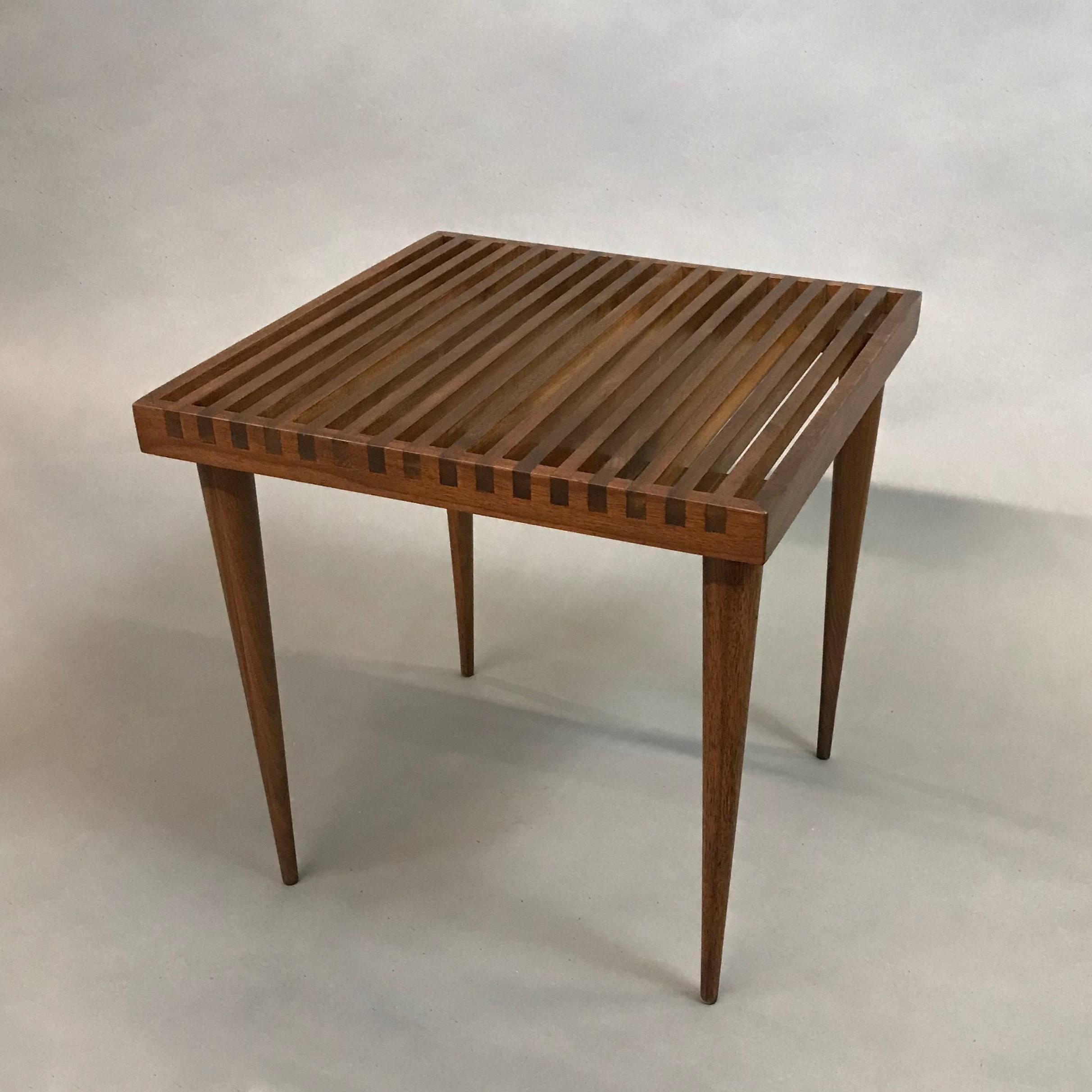 Mid-Century Modern, slatted walnut side table with elegant dovetail details and tapered legs designed by Mel Smilow.