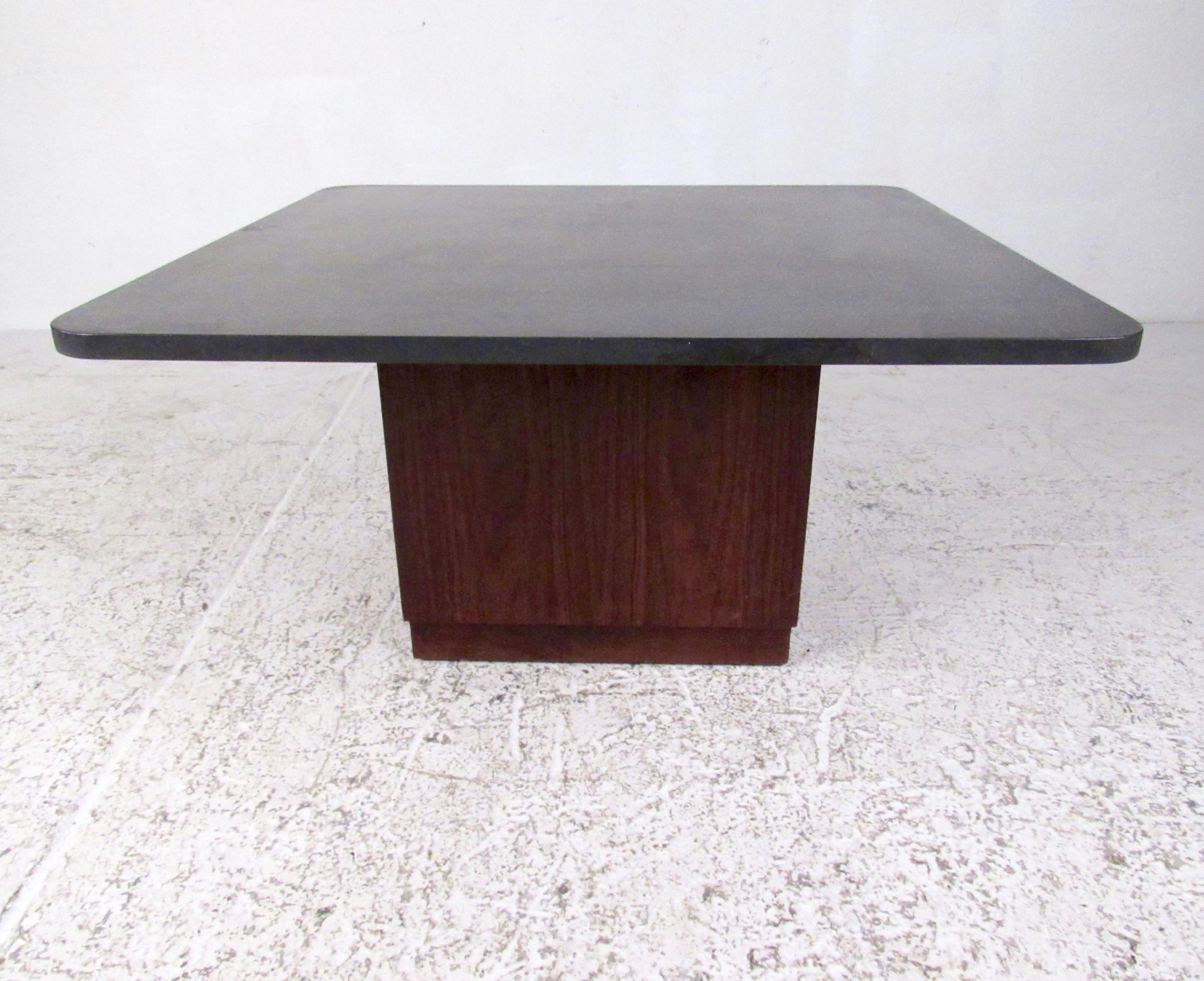 This stylish midcentury coffee table features vintage walnut base, square stone top, and unique Pearsall style design. At 32 by 32 inches this impressive 1960s table works as an end table or centre coffee table depending on the seating arrangement.
