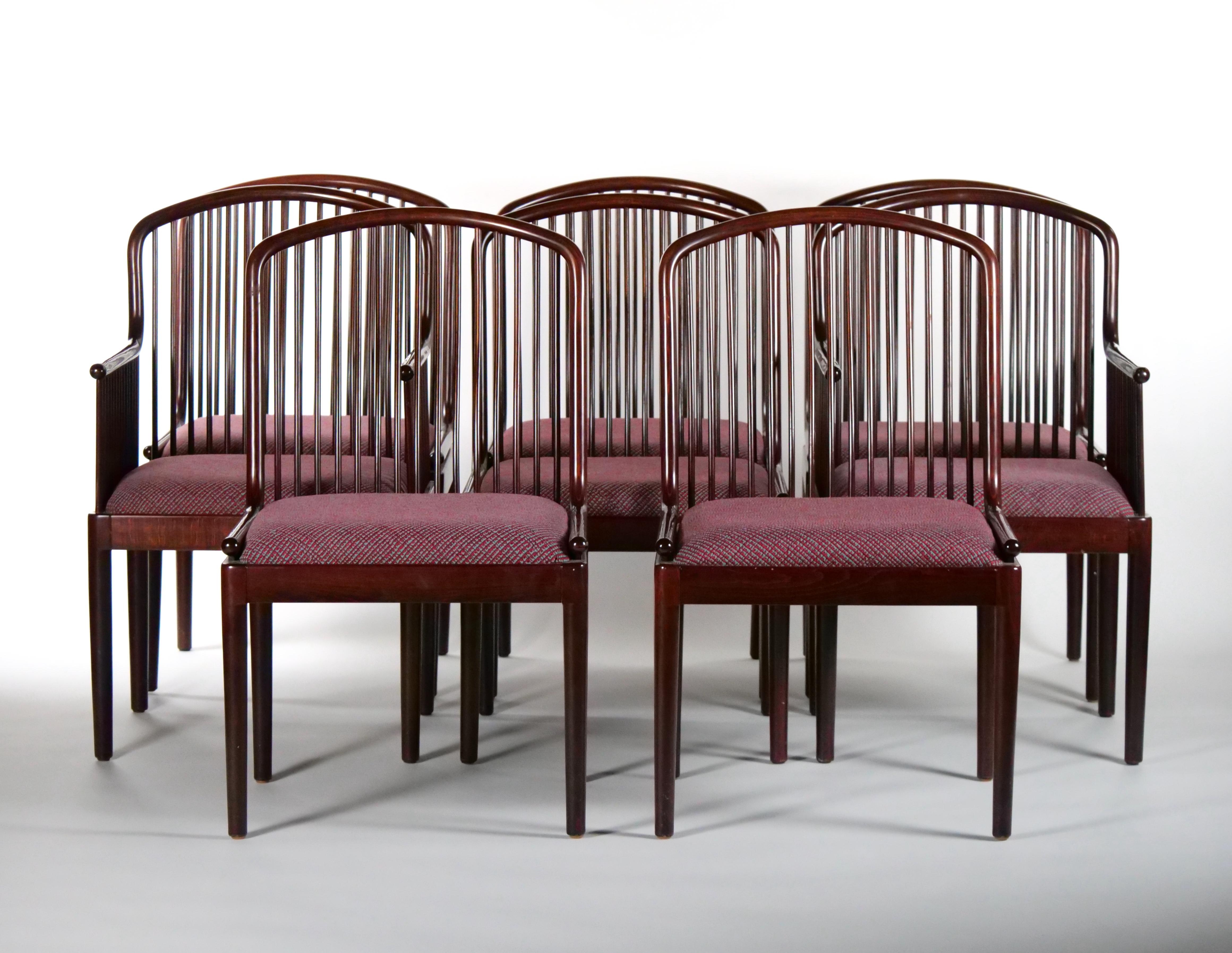 Beautiful craftsmanship set of eight Mid-Century Modern dining room chair. The set include six side chairs and two armchairs. The armchair features a slatted back design with straight barrel legs and conforming armrests. Each seat is upholstered