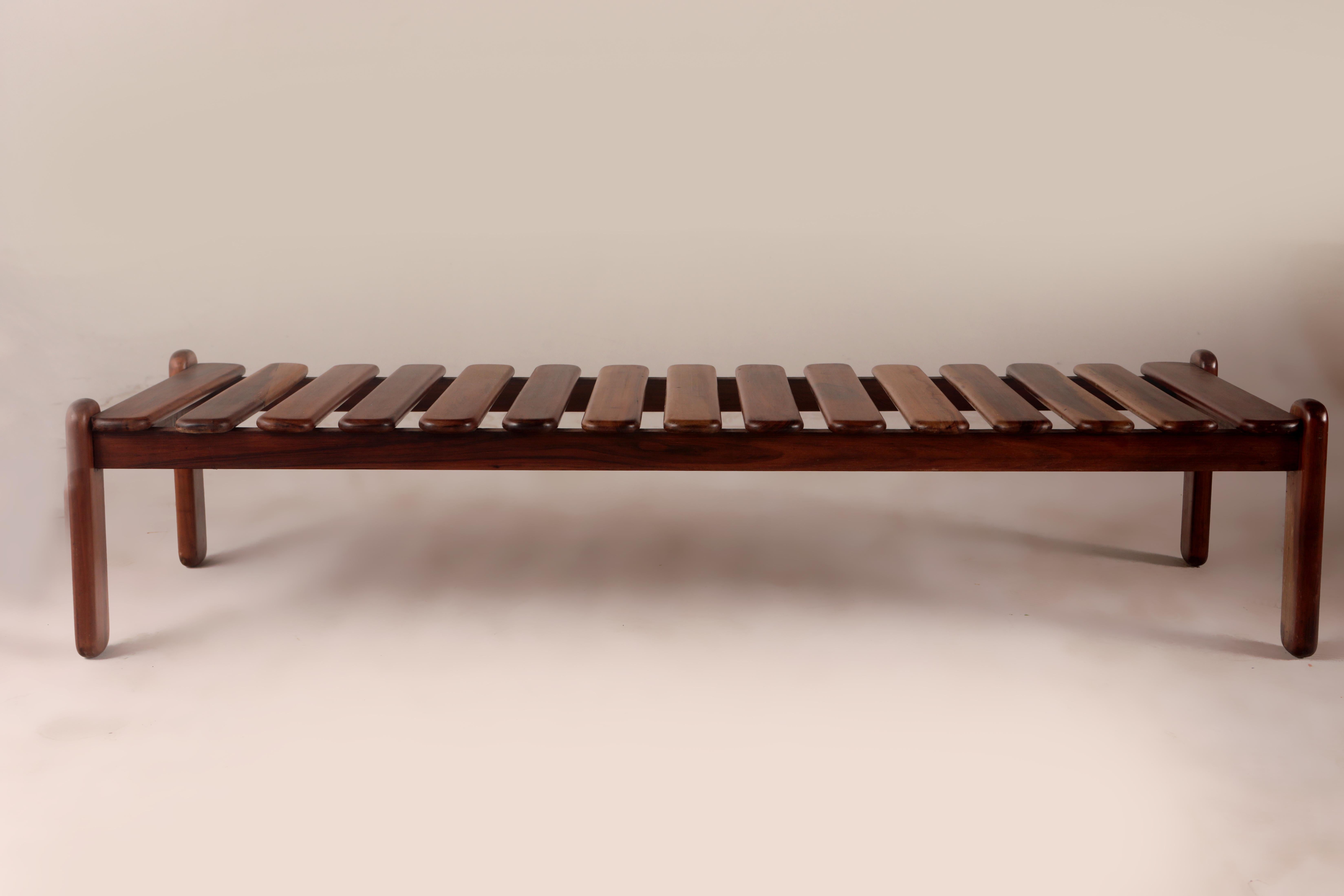 Mid-Century Modern slatted bench by Celina Decorações, Brazil 1960s.

Produced in the late 1960s, this bench consists of solid wooden slats with rounded edges, supported by four legs. 
Based in Rio de Janeiro, Celina Decorações produced