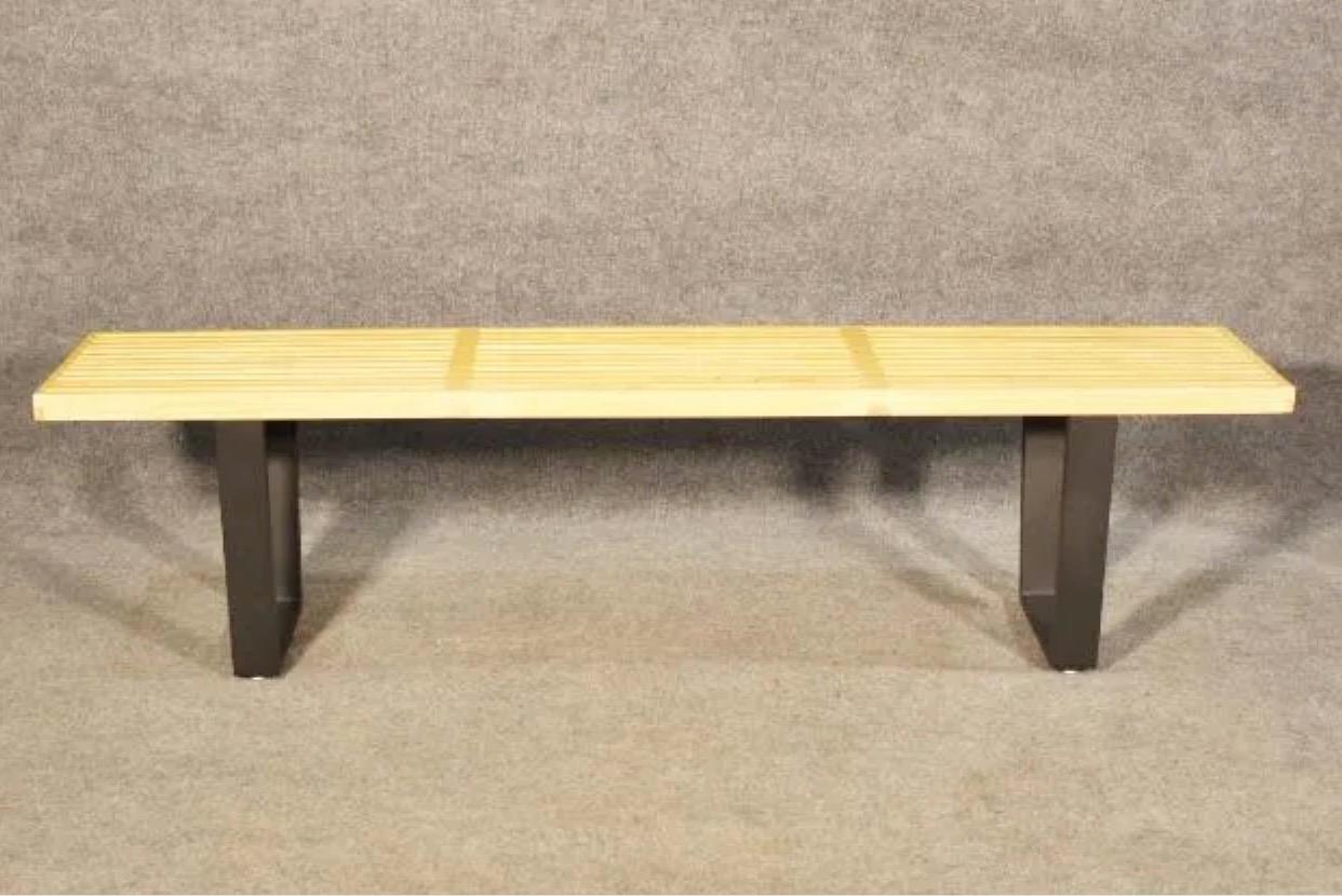 A simple and stylish piece of Mid-Century Modern design, this vintage slat bench combines a wooden top with dark metal legs. Please confirm item location with seller (NY/NJ).