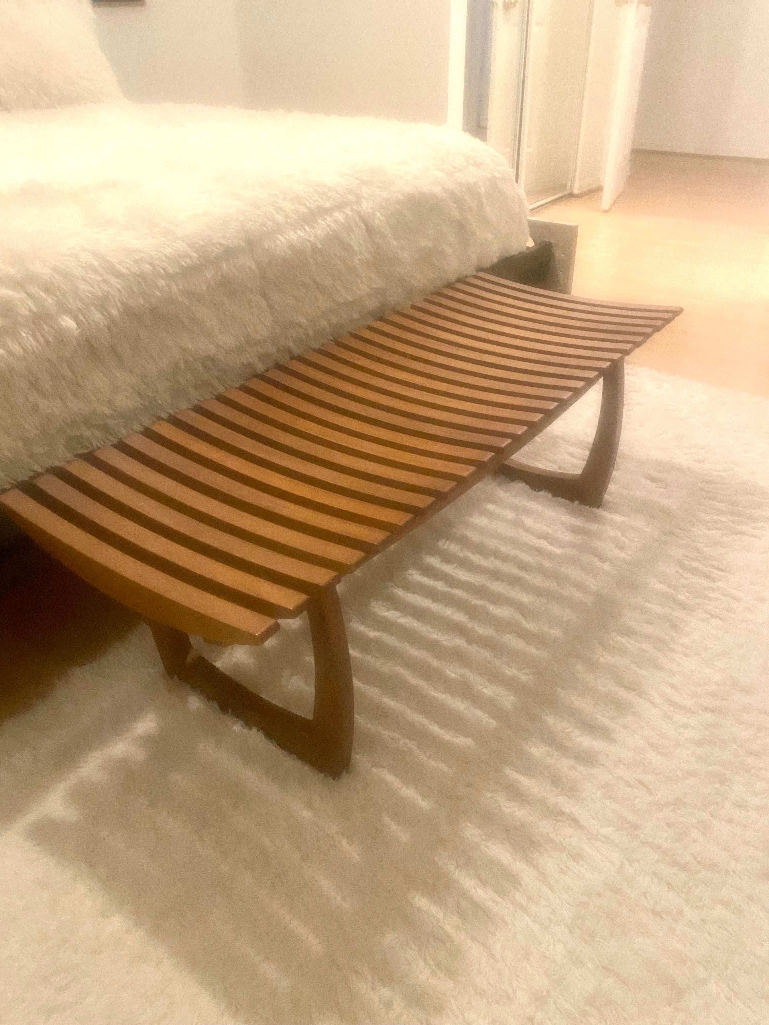 Mid- Century Modern Danish style curved and slatted wood bench. This piece can serve as a coffee table also.