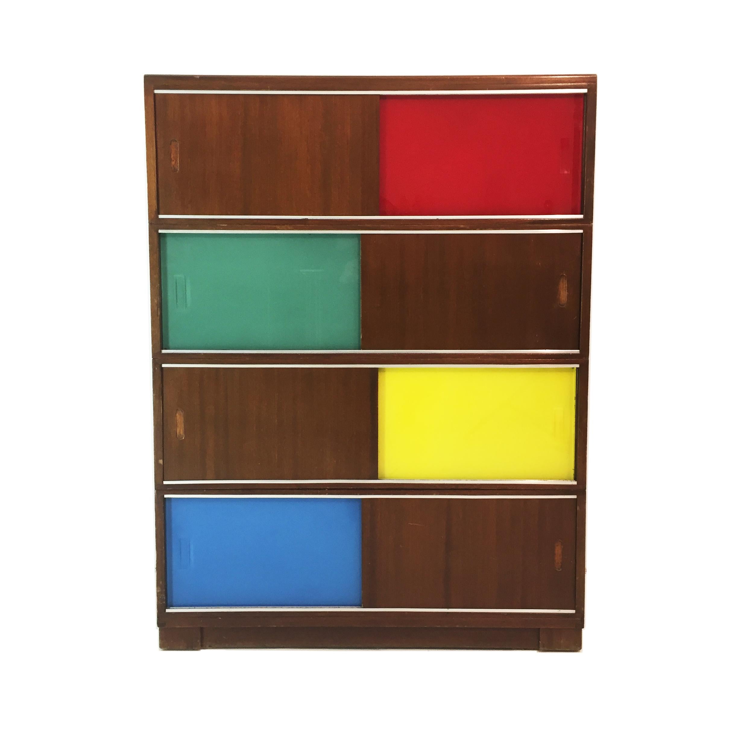 A sliding door cabinet with glass and wood panels. The glass panels are colored in pure Mid-Century Modern tones and in the style of Le Corbusier. The design and colored slide doors resemble those of Claude Vassal cabinets. A truly practical and