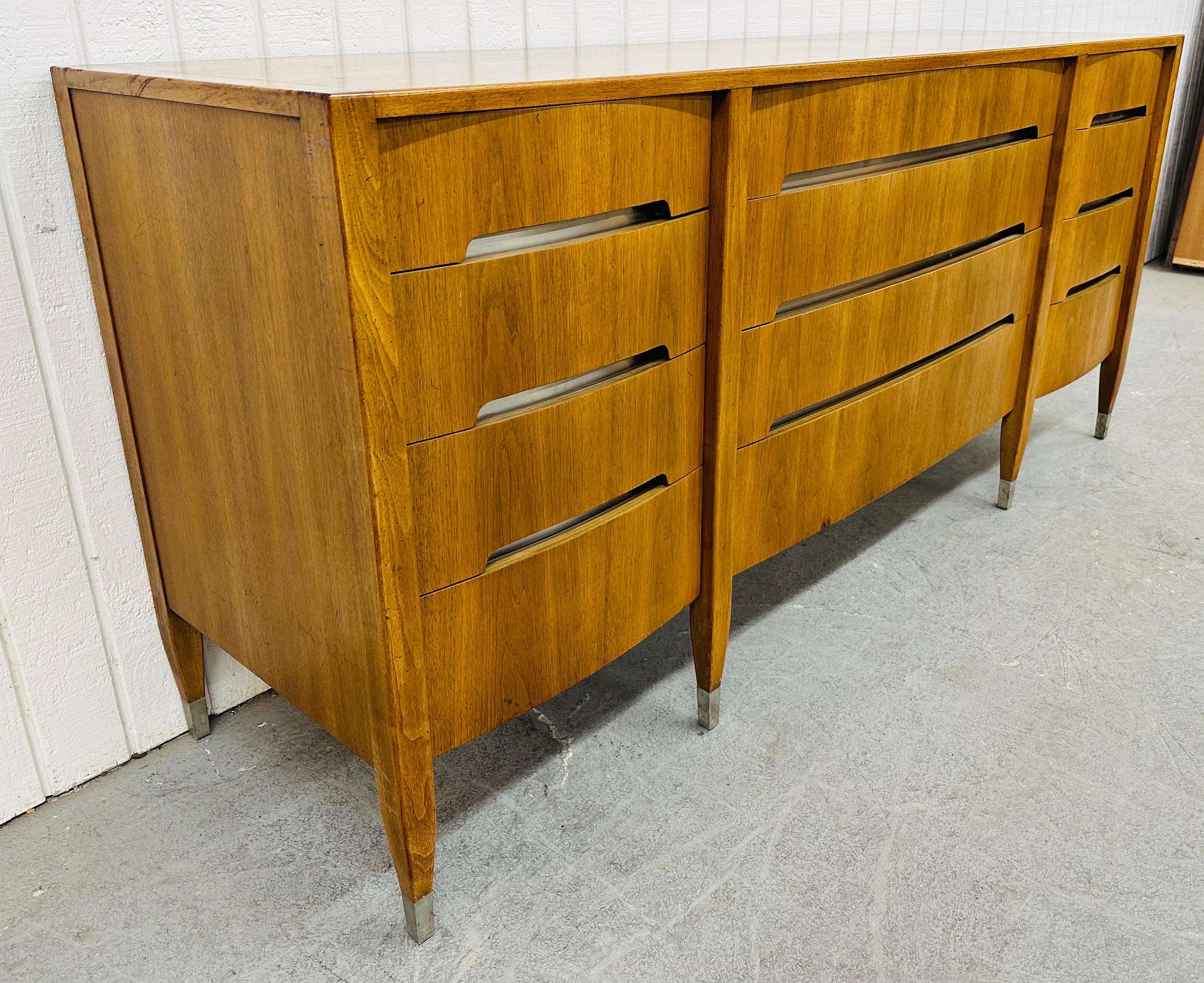 This listing is for a Mid-Century Modern Sligh Walnut 12-Drawer Dresser. Featuring a straight line design, twelve drawers for storage, recessed handles, chrome trim with caps on the feet, and a beautiful walnut finish. This is an exceptional