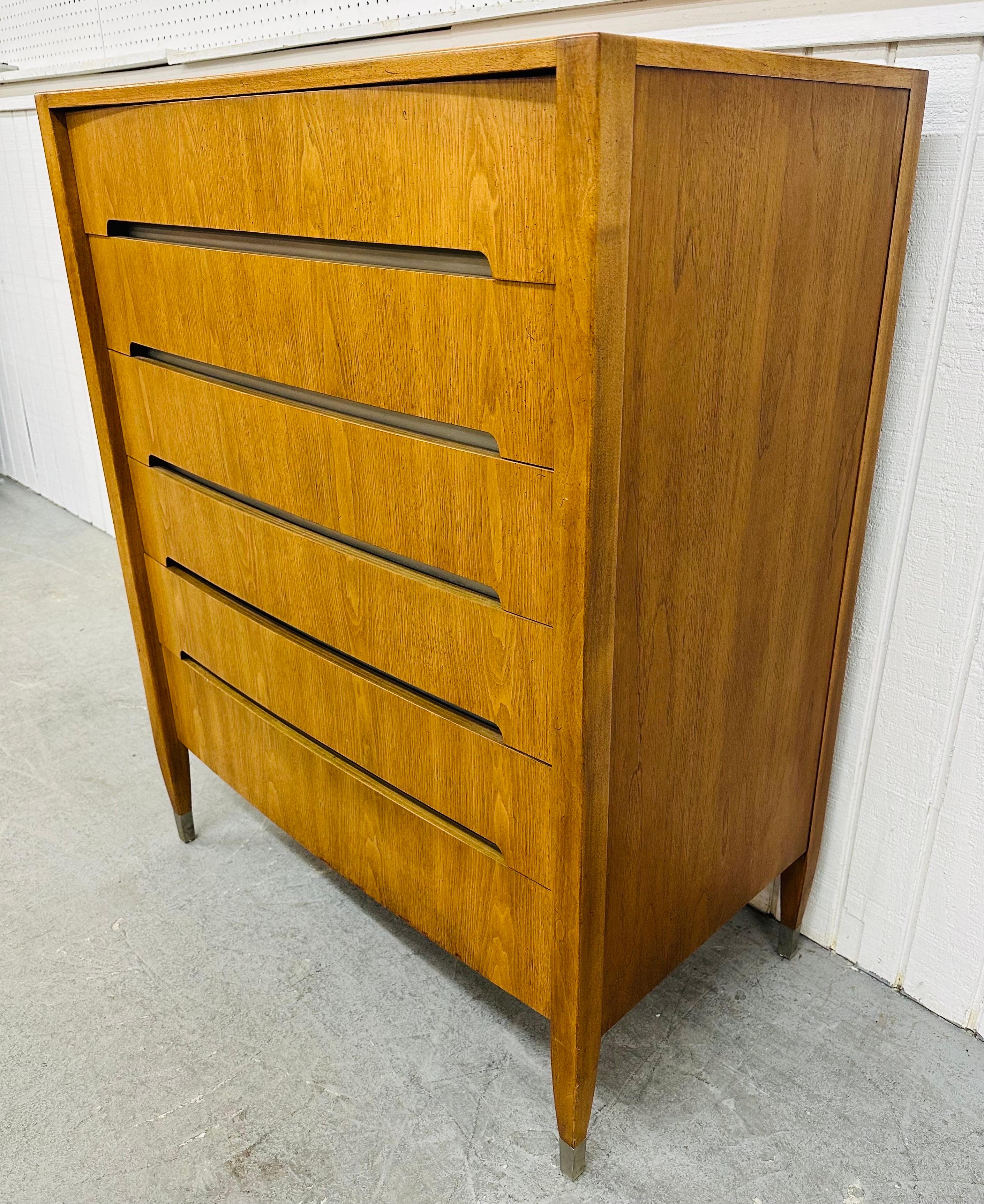 This listing is for a Mid-Century Modern Sligh Walnut High Chest. Featuring a straight line design, six drawers for storage, recessed handles, chrome trim with caps on the feet, and a beautiful walnut finish. This is an exceptional combination of