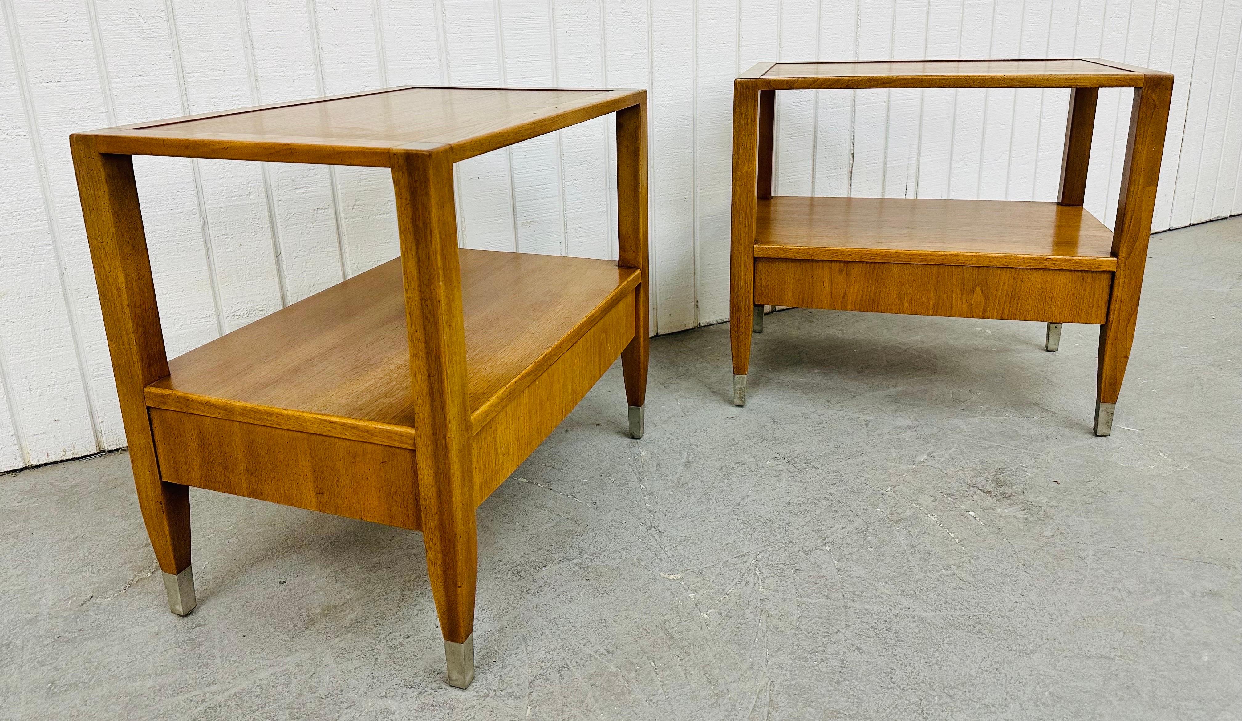 This listing is for a pair of Mid-Century Modern Sligh Walnut Nightstands. Featuring a straight line design, two tiers for storage, a single drawer, chrome caps on the feet, a finished backside, and a beautiful walnut finish. This is an exceptional