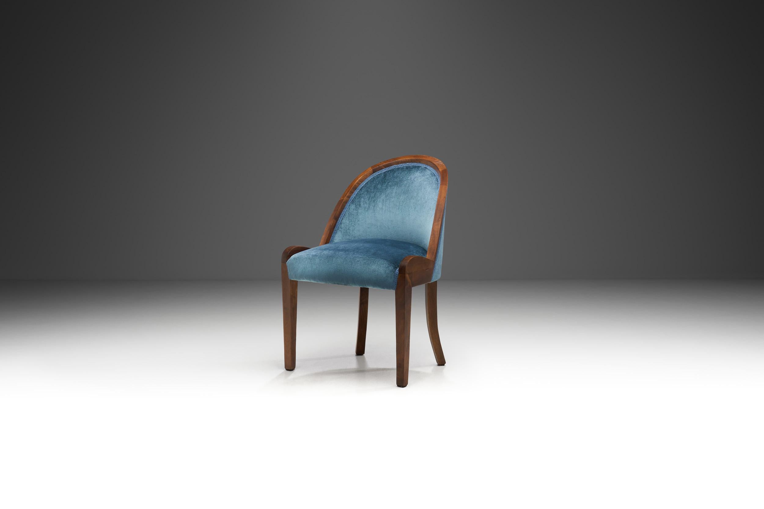 Slipper chairs received their name during the Victorian era, when they were used to comfortably seat high-class women while they put on their shoes or slippers. Evident with this beautiful blue chair, slipper chairs usually lack arms and sit low to