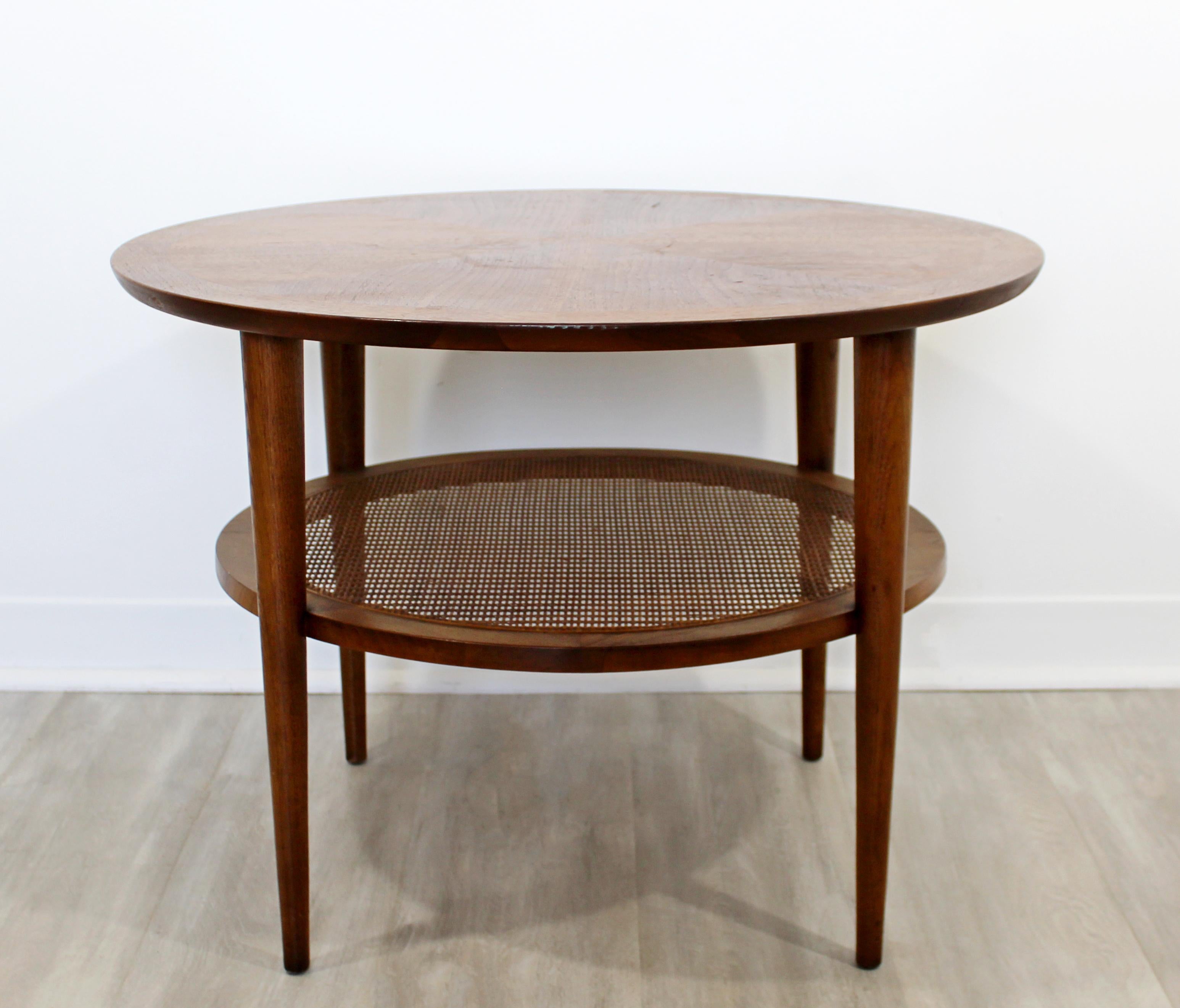 Nous vous présentons une phénoménale petite table basse circulaire:: en bois:: avec une étagère en rotin:: par Lane Altavista:: vers les années 1960. En excellent état vintage. Les dimensions sont de 28