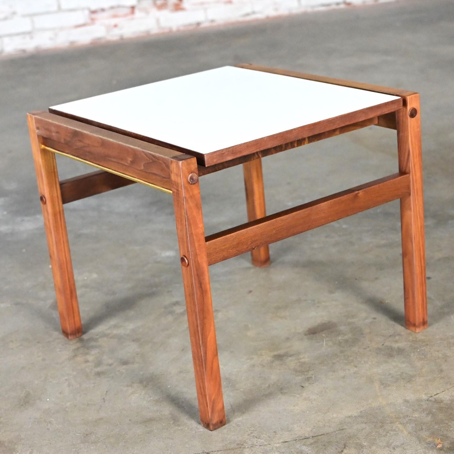 Lovely Mid-20th Century Mid Century Modern small square side table comprised of a teak frame and a white laminate top. Beautiful condition, keeping in mind that this is vintage and not new so will have signs of use and wear even if it has been