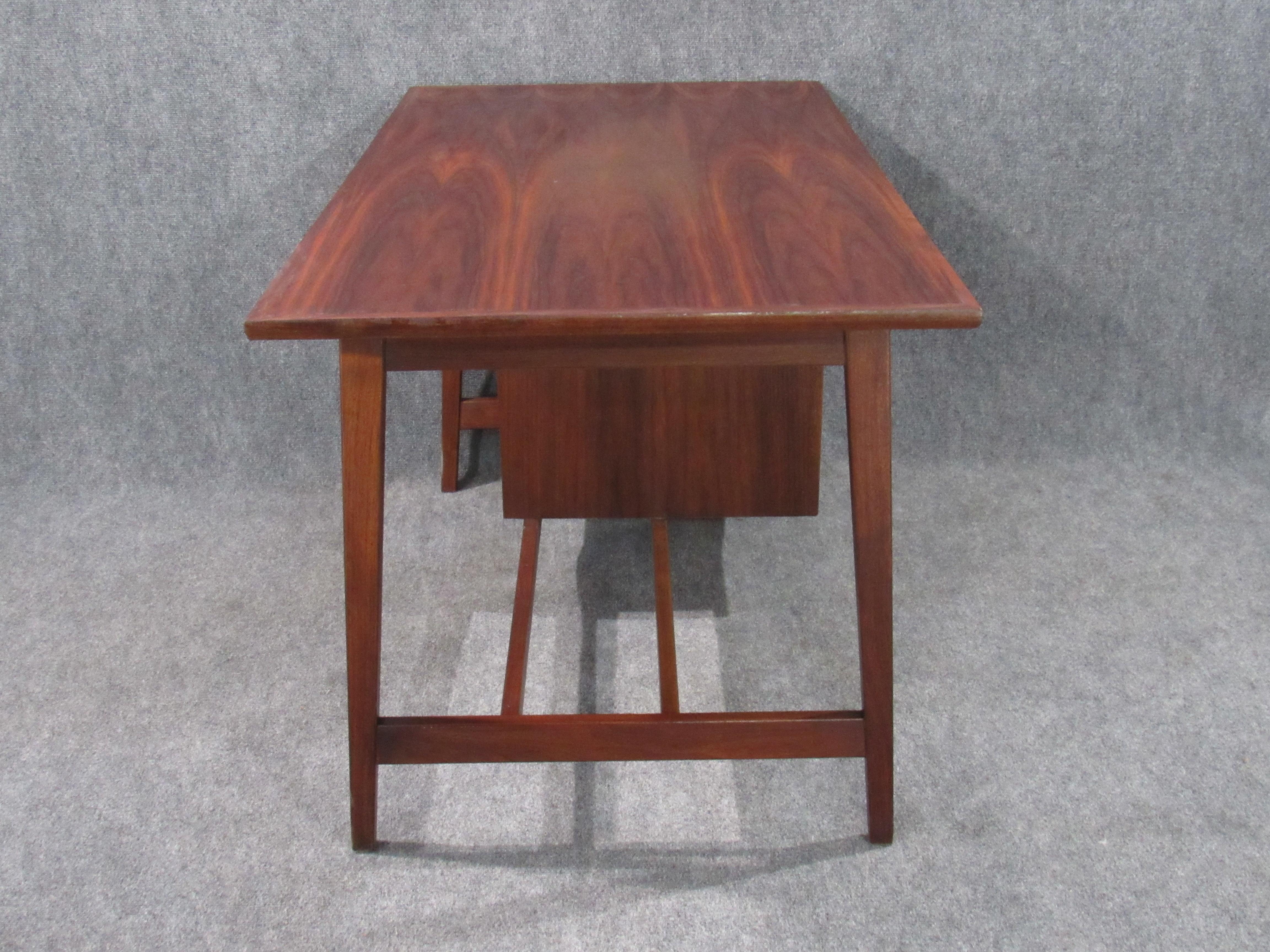 Mid-Century Modern small walnut desk with round pulls, circa 1970s.