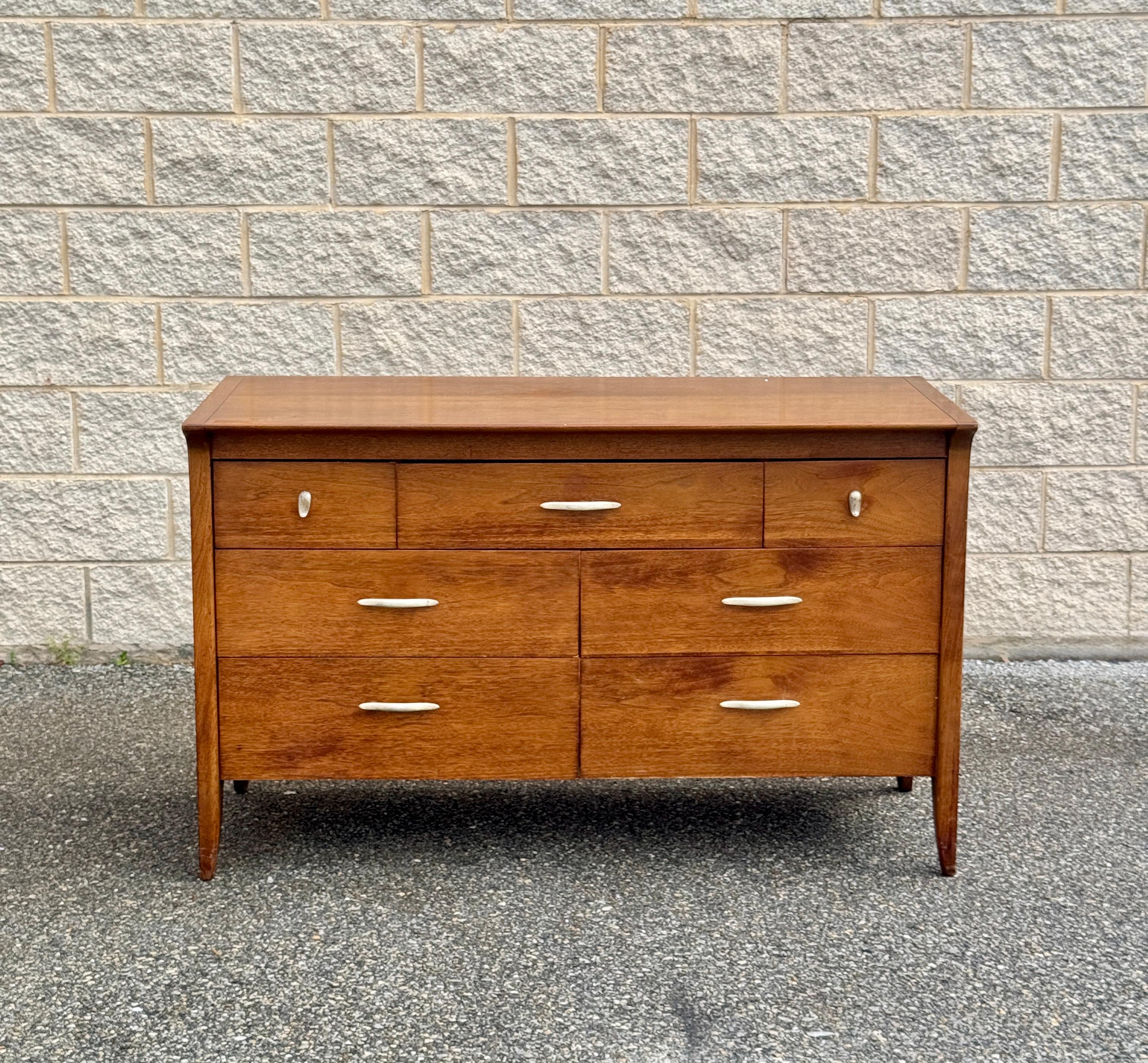 The walnut dresser by Drexel dates to the 1960s. It showcases the clean lines and timeless appeal of mid-century modern design. Featuring four spacious drawers and two smaller upper drawers.  Tapered legs and a solid build complete the