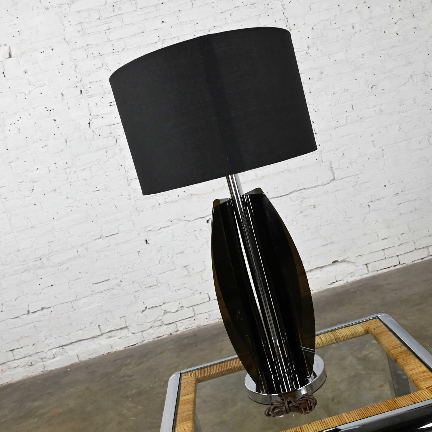 Absolutely awesome, circa 1960s, Mid-Century Modern smoke gray/grey Lucite and chrome table lamp with new black drum shade which as always you can let us know if you would like the lamp shipped with or without the shade. Beautiful condition, keeping