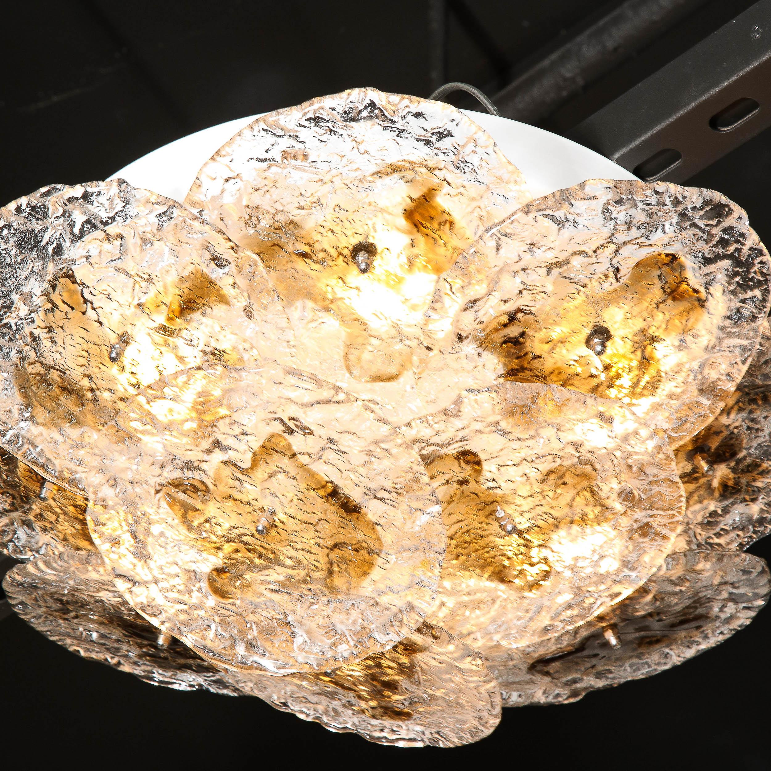 This beautiful Mid Century Modern flush mount chandelier was realized by the legendary atelier of Mazzega in Murano, Italy- the island off the coast of Venice renowned for centuries for its superlative glass production- circa 1970. It features an