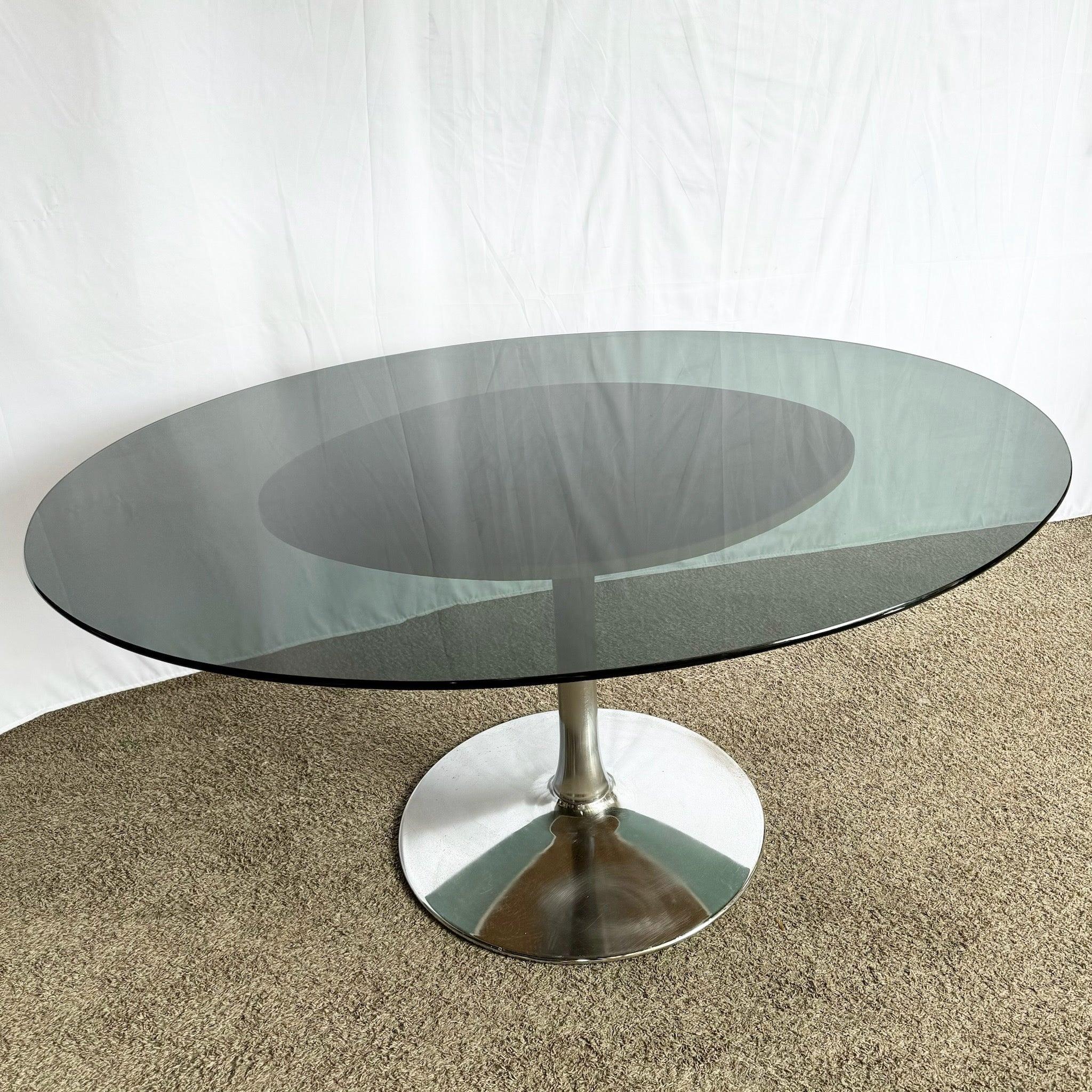 Mid-Century Modern Smoked Glass Tulip Table with polished chrome base—adds vintage charm and elegance to any dining space.​
 
 Pitting and wear to the chrome as shown in the photos. 
 
 We sell items as acquired, without restoring or repairing.