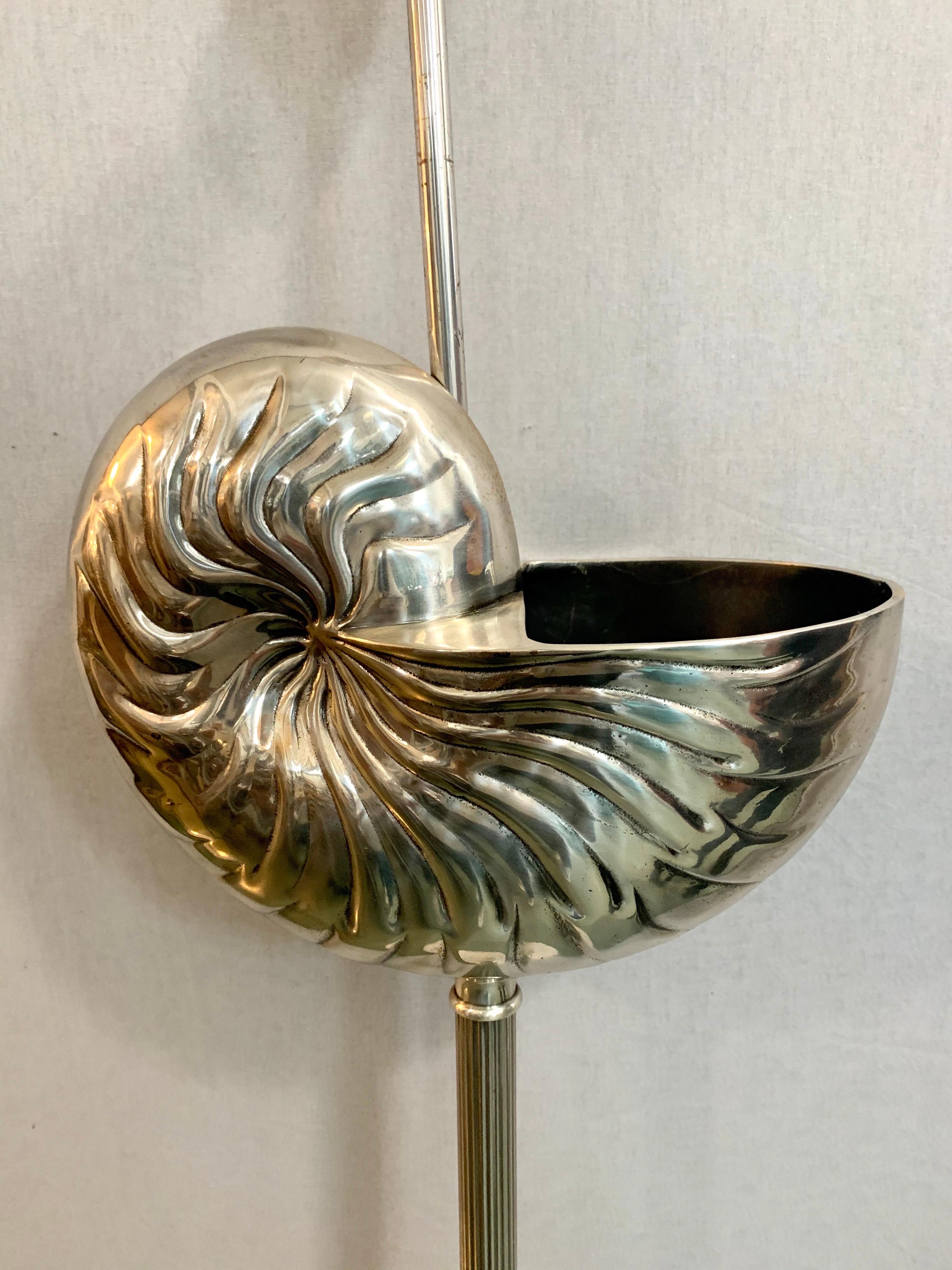 Unusual tall Mid-Century Modern snail shell silver floor lamp with one bulb.
Wired for USA and in perfect working order. Now, more than ever, home is where 
the heart is.