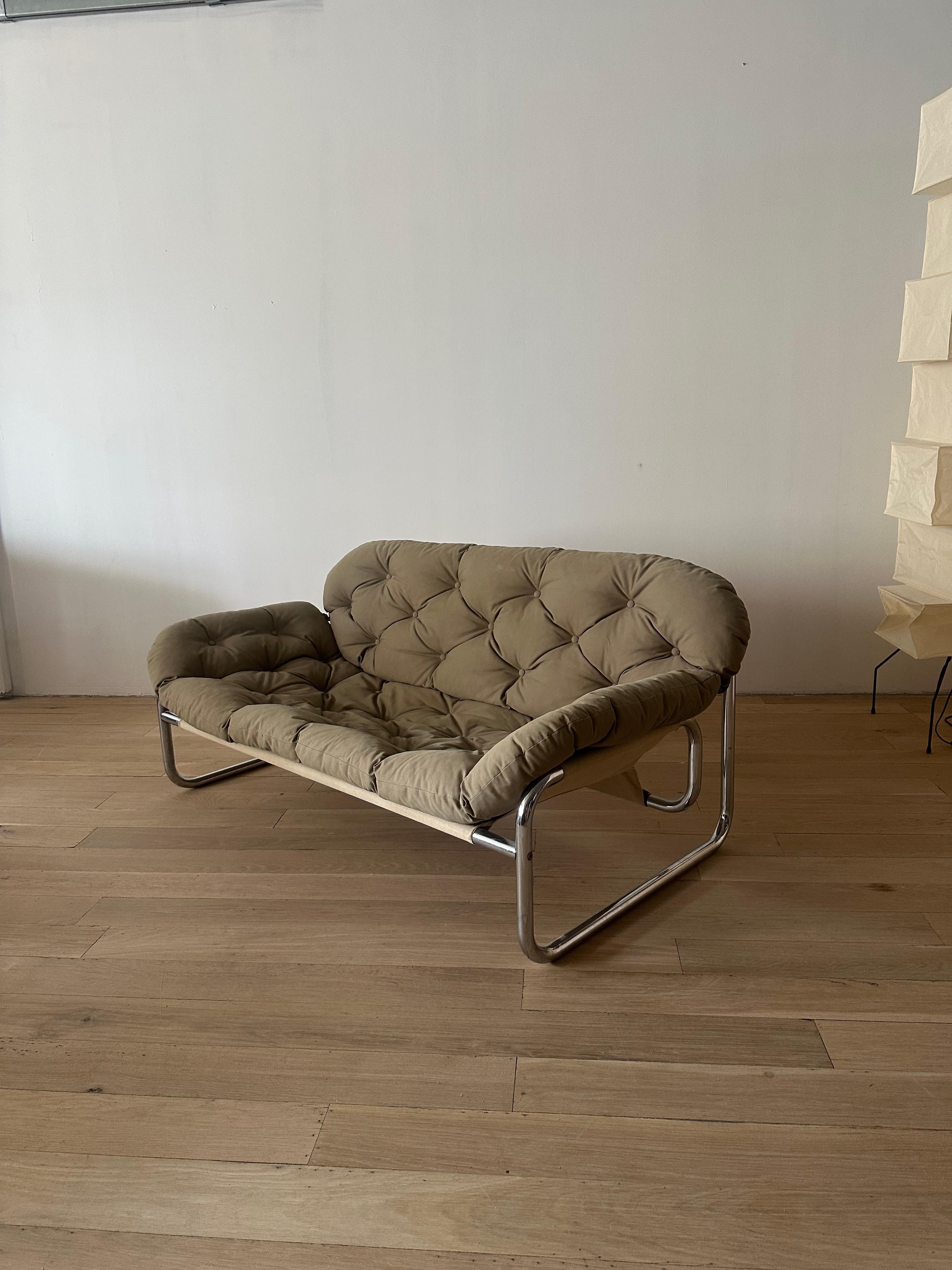 This vintage sofa and lounge chair, designed by Johan Bertil Häggström for Swed-Form, is an iconic example of 1970s Swedish Postmodern design. This set features a tubular chrome frame that adds both structure and a touch of industrial elegance. The
