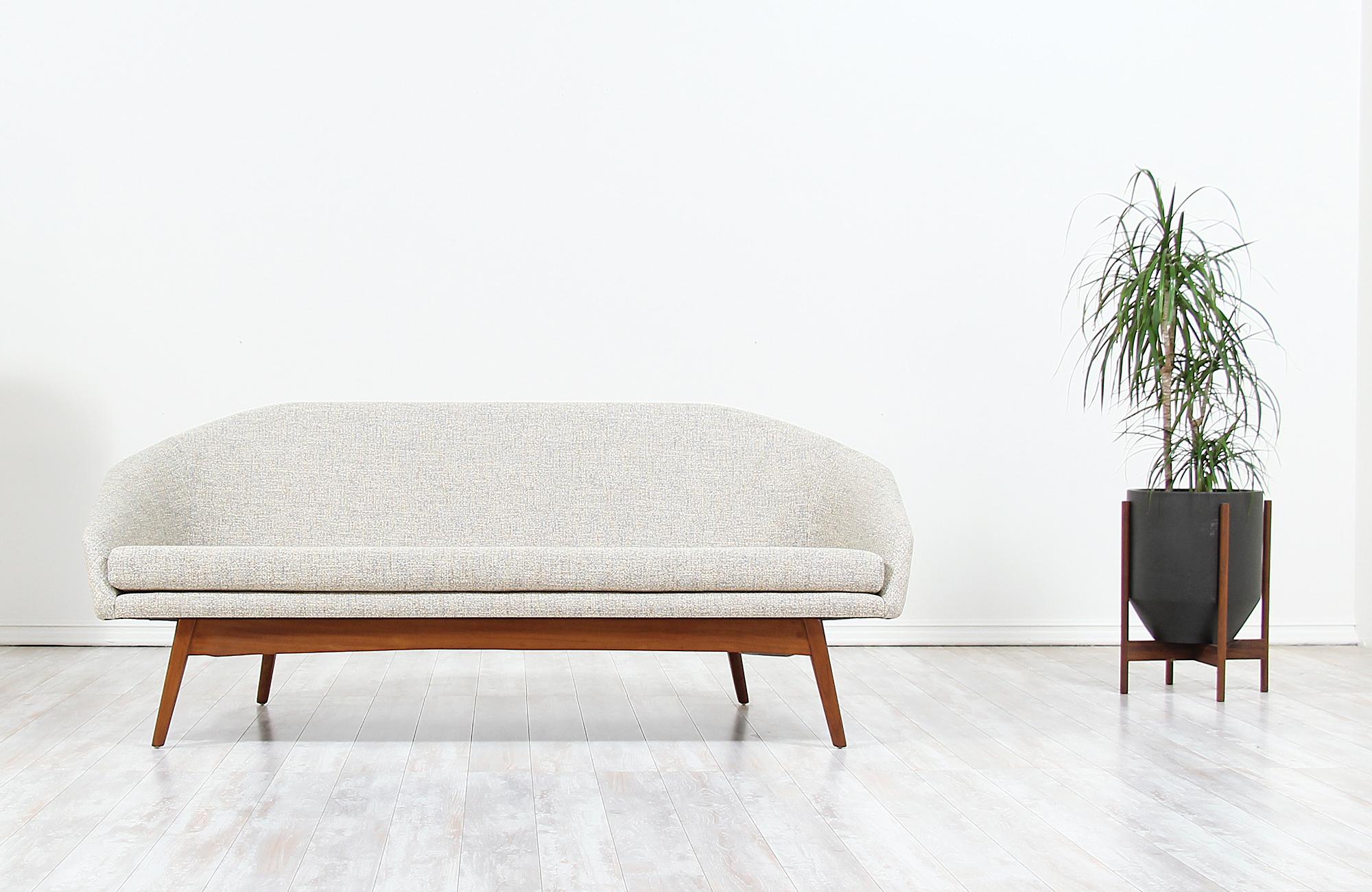 Elegant Mid-Century Modern sofa designed by Jan Kuypers for Imperial Furniture in Canada, circa 1950s. This comfortable design features a quality crafted Afromosia teak wood base and a perfectly balanced seat with new high-density foam and tweed