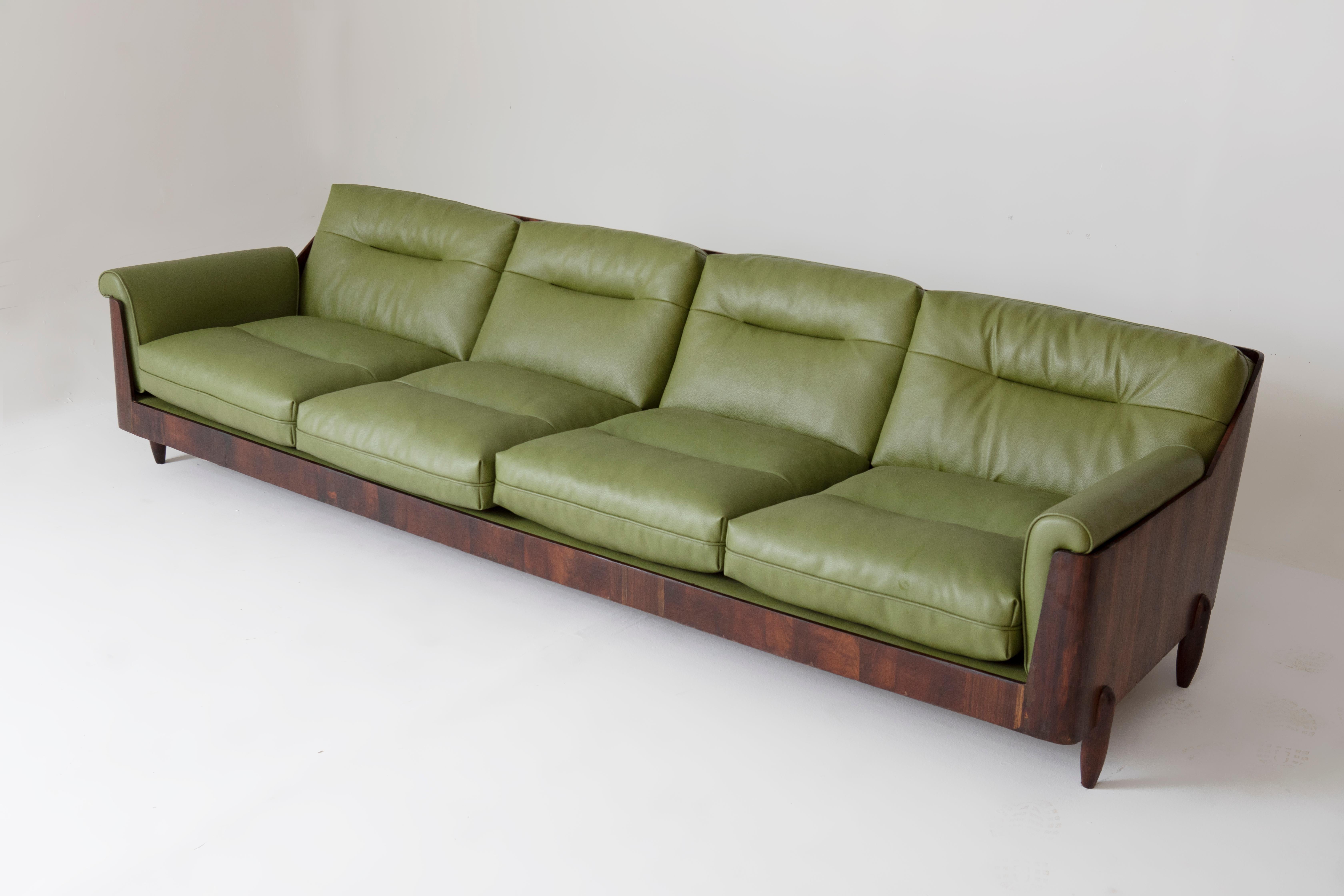 Mid-Century Modern Sofa by Novo Rumo, 1960s

Four-seater sofa manufactured by Novo Rumo, 1960s in Brazil is a great example of Brazilian Modern Design, blending functionality with aesthetic appeal. 
This sofa features a distinct hollow wooden frame,
