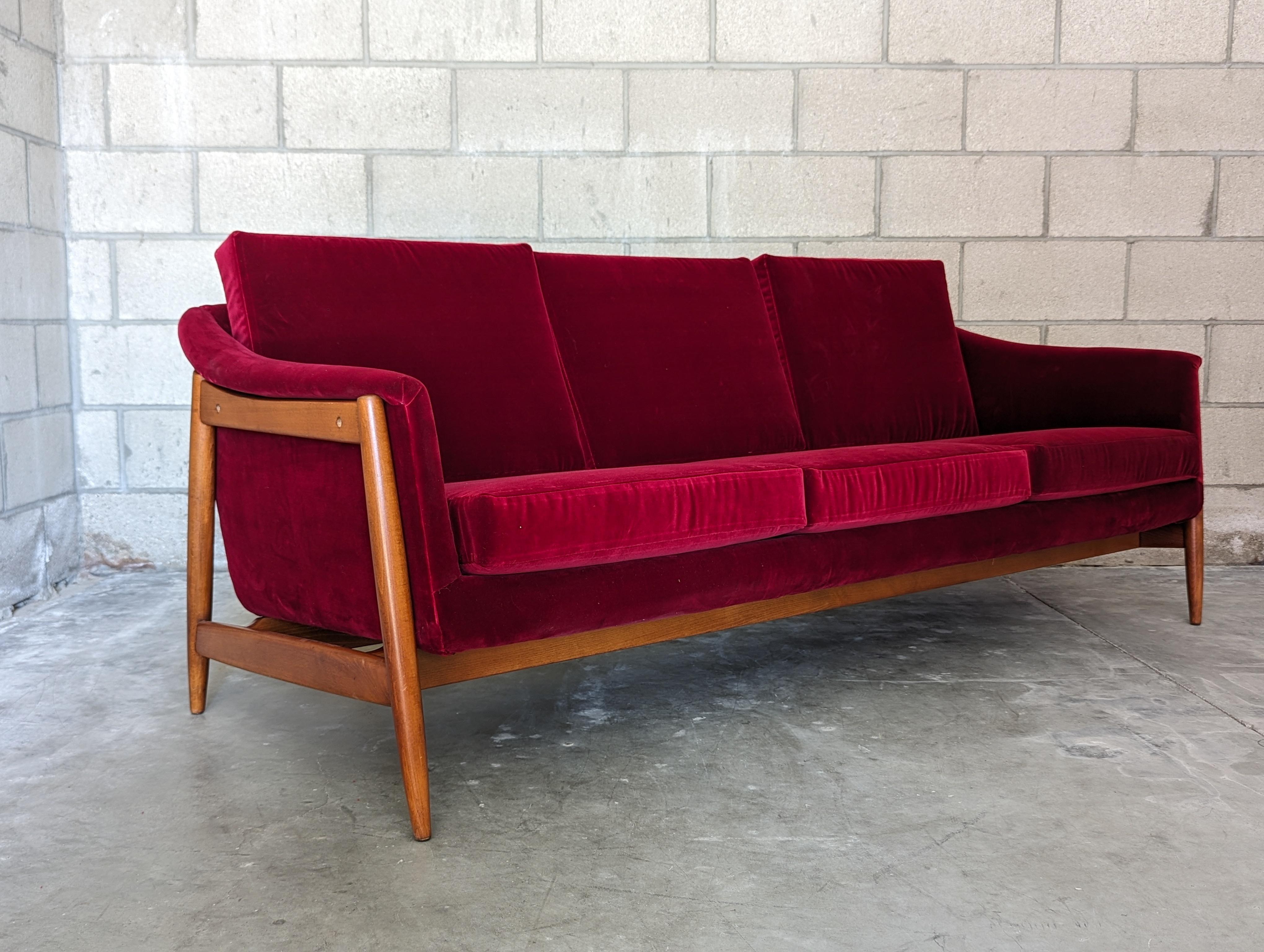 Step into a world where the past meets the present with this beautifully restored vintage mid-century modern sculptural sofa. Designed by the iconic Folke Ohlsson for Dux of Sweden in the 1960s, this sofa is more than just a piece of furniture -