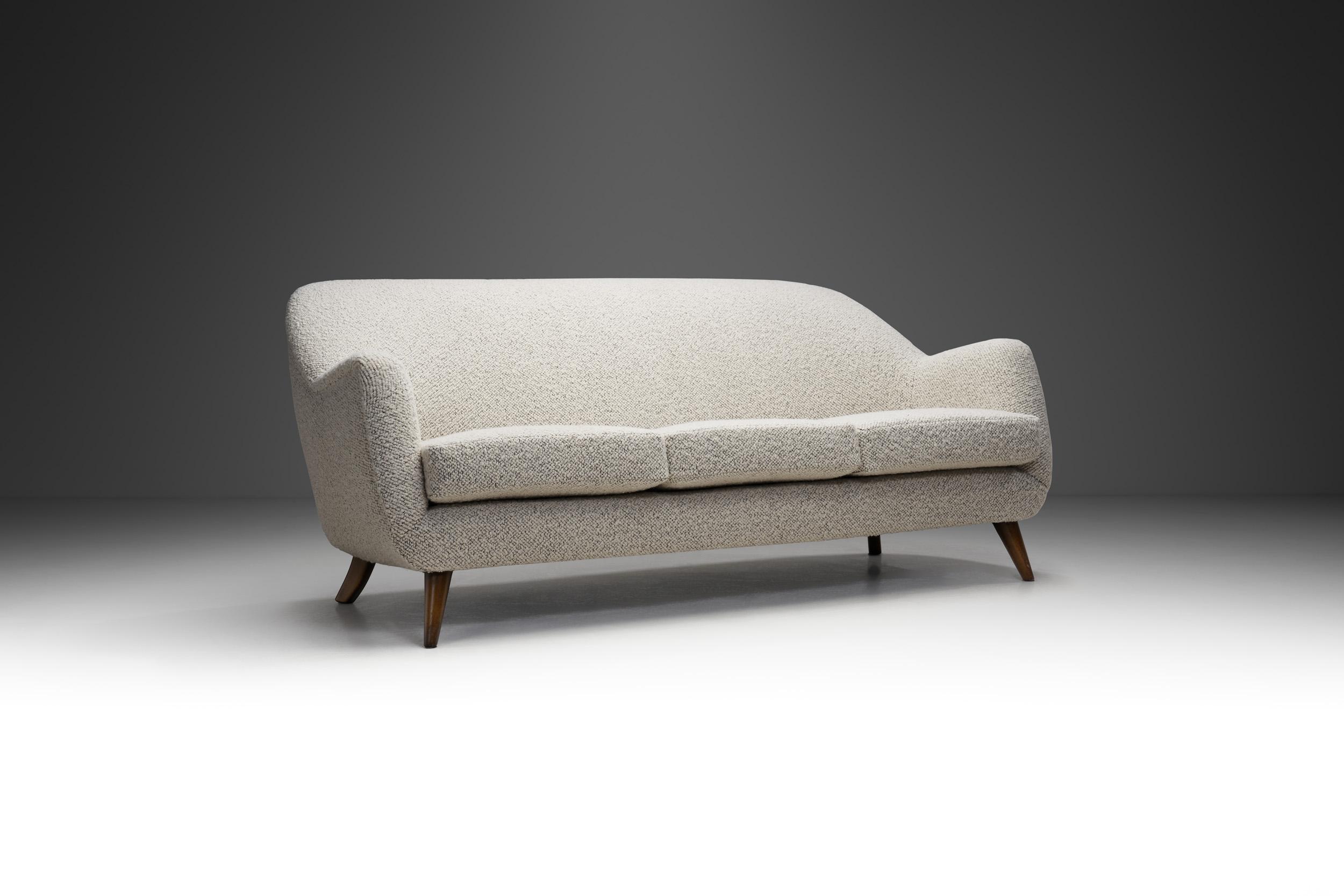 Mid-century design is typically characterized by clean, simple lines and honest use of quality materials. It also generally includes minimal, tasteful use of decorative embellishments. This sofa is a lovely example from this design period.

The