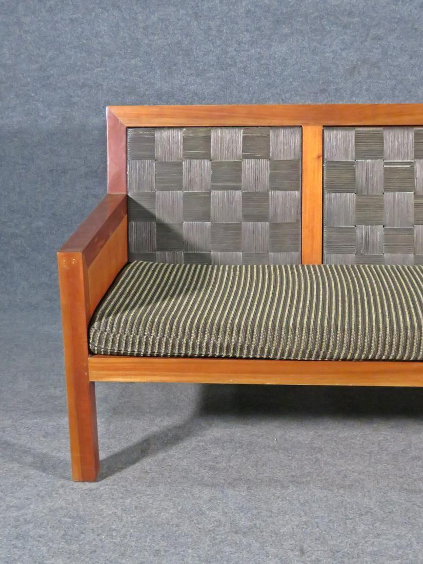 Eye-catching patterned seats and backs are complemented by a rich wooden frame in this vintage Mid-Century Modern sofa. Perfect for adding a unique look to any living room. Please confirm item location with seller (NY/NJ).
