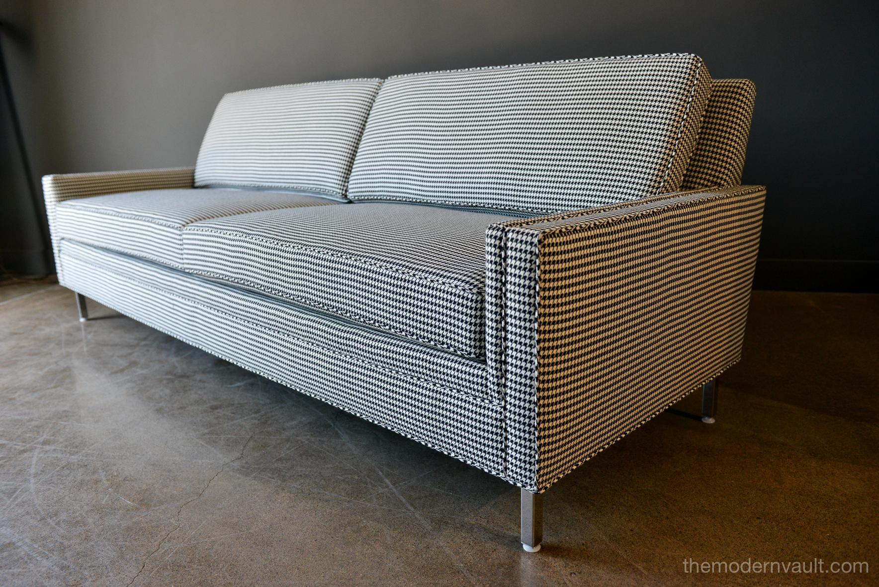 Mid-Century Modern sofa in black and white houndstooth, circa 1955. Professionally re-upholstered with new foam and fabric in beautiful black and white houndstooth fabric. Originally custom made for Richard Showrooms in Beverly Hills, circa 1950s.