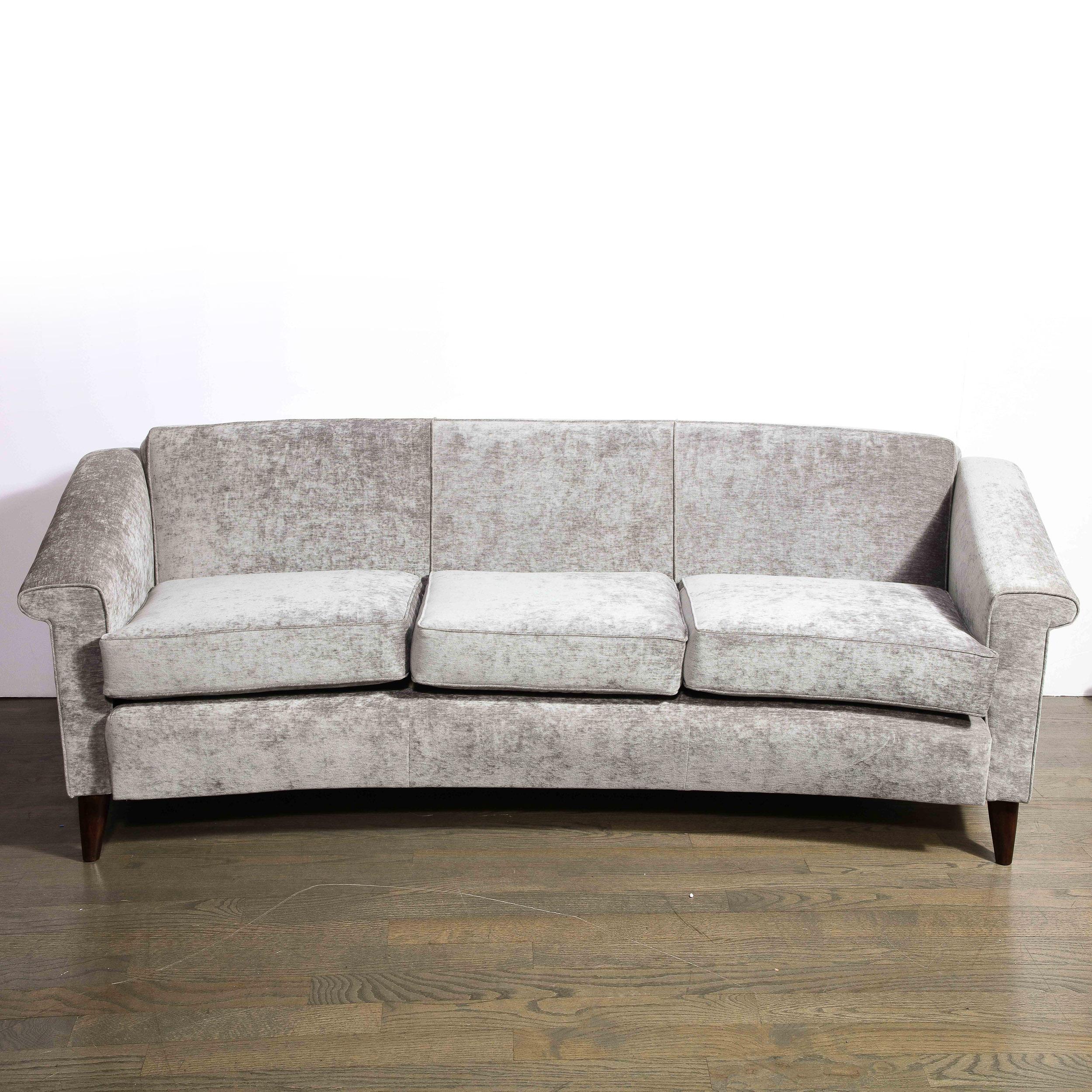 This elegant Mid-Century Modern sofa was realized by the legendary Jules Leleu in France circa 1950. It offers the clean silhouette, attention to detail and timeless (yet perenially modern) aesthetic that discerning collectors of Leleu's designs