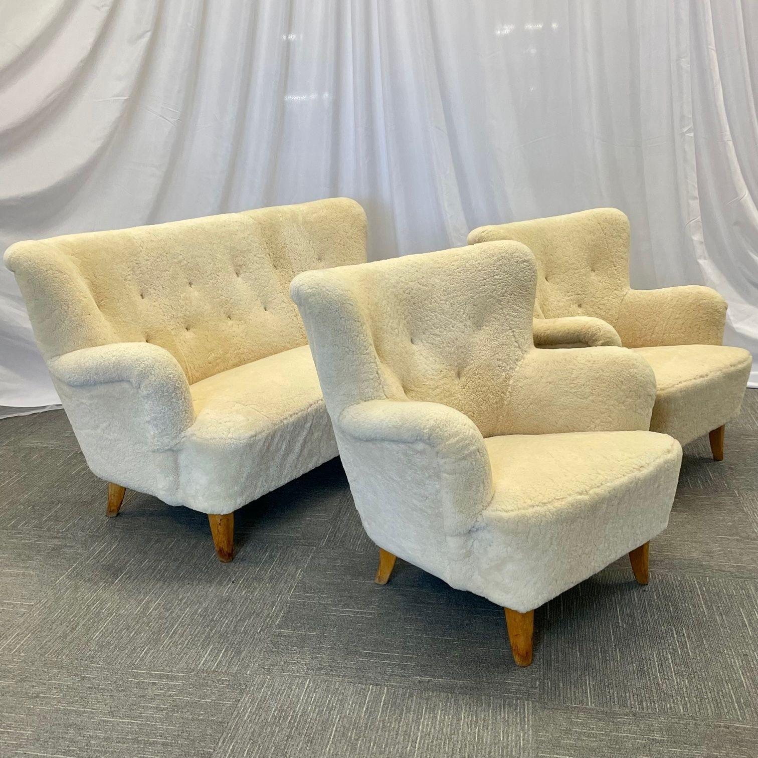Mid-Century Modern 'Laila' Sofa Set by Ilmari Lappalainen for Asko, Finland; Settee and Lounge Chairs
 
Chic and stylish Finnish designer 5-seater sofa set newly upholstered in genuine cream Sheepskin. Both the sofa and the pair of lounge chairs