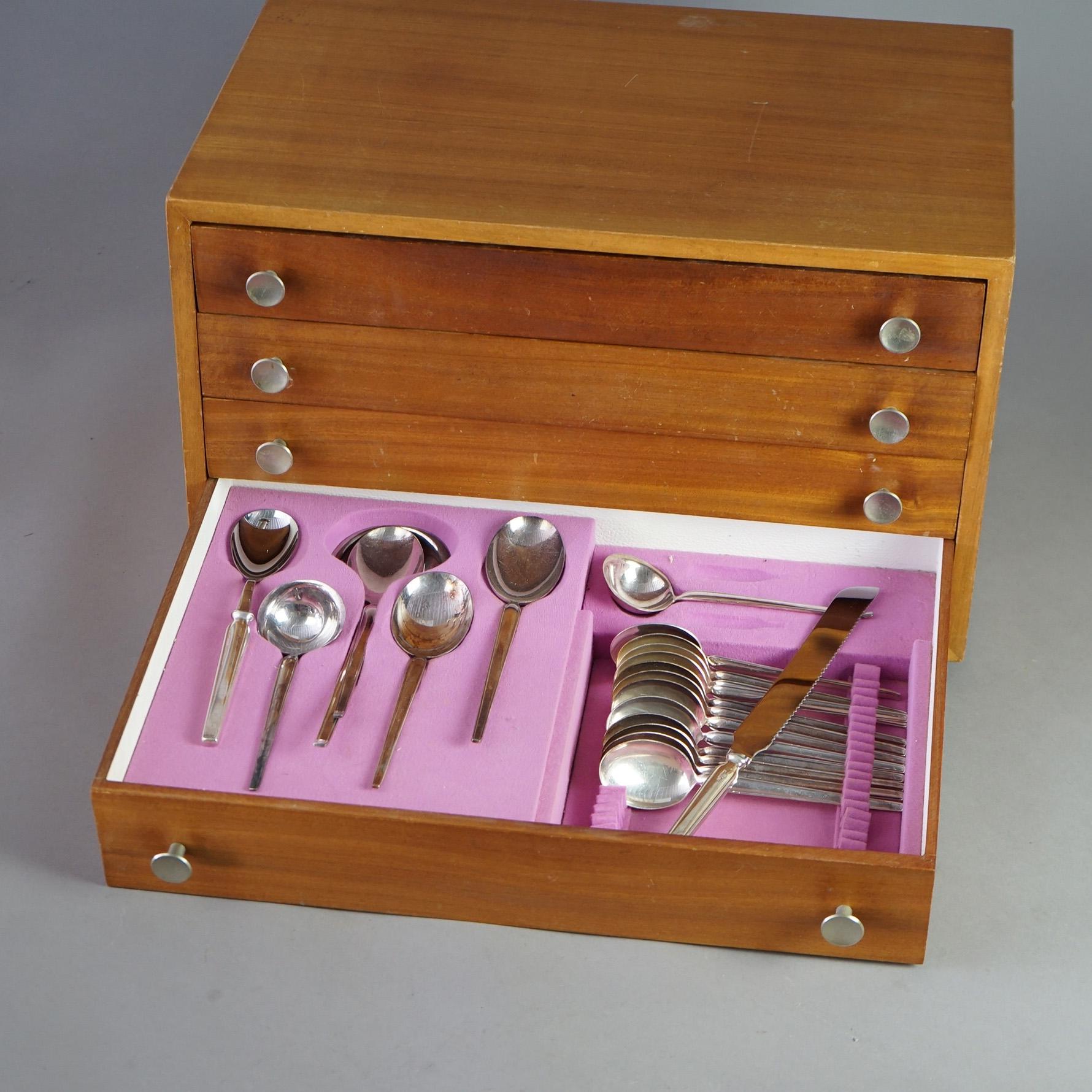 A Mid Century Modern set of 179 pieces of stainless steel flatware by Sola Elite offers flatware and serving pieces in teak wood silverware chest having four drawers, maker mark as photographed, some mismatched pieces as photographed, 20th