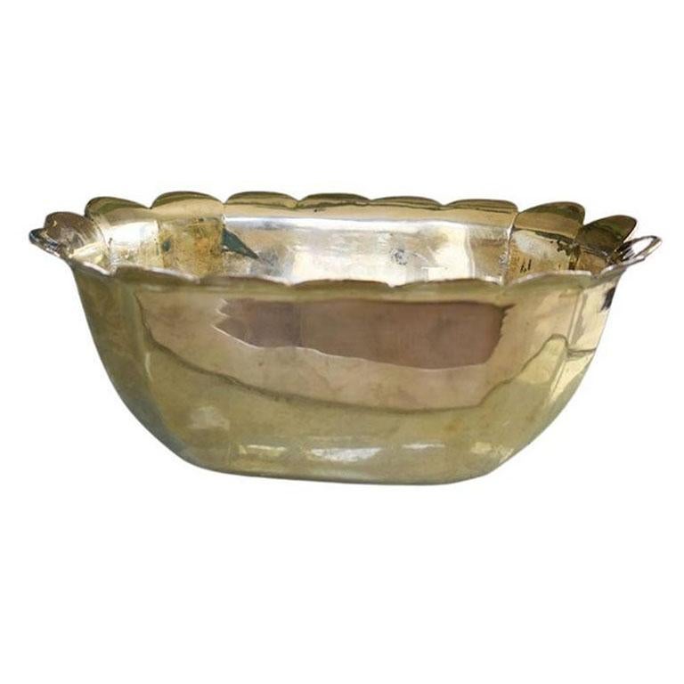 A heavy solid brass Mid-Century Modern cachepot or planter. This piece is oval in shape and has scalloped edges encircling the rim. The bottom is solid with no drainage holes or makers mark. This would be a fantastic piece amongst maximalist or
