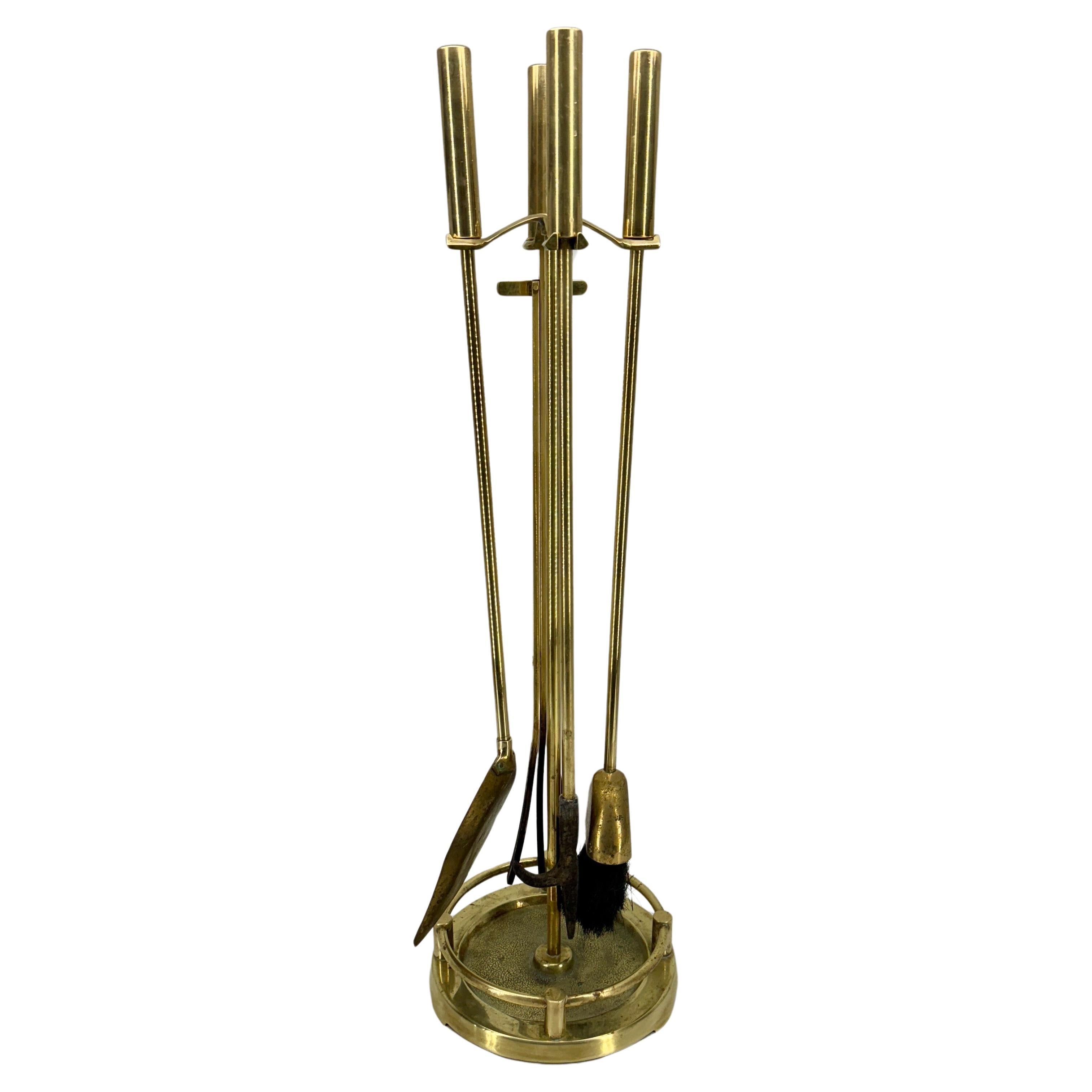 Four Piece Set of Solid Brass Fireplace Tools. Great classic vintage set with wonderful newly polished patina. This Mid-Century set is sleek and would be functional in a modern as well as traditional setting.
