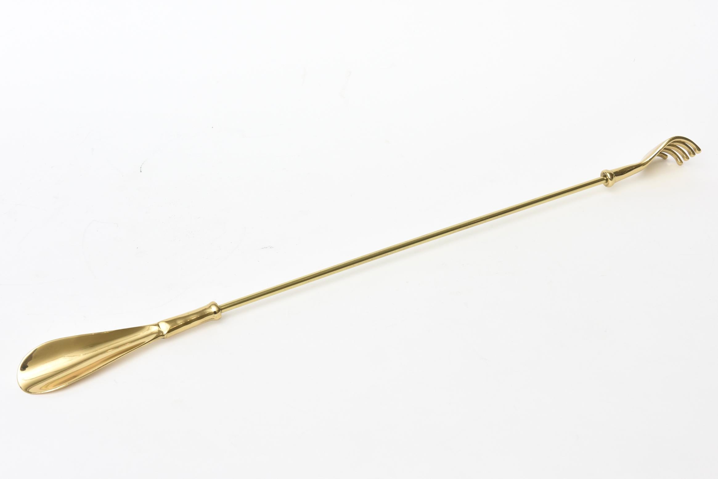 This vintage mid century modern sold brass 1950's long shoe horn with hand back scratcher is whimsical and useful. It serves 2 wonderful dual purposes.. A great duality at both ends. It has all been professionally polished. It is 22