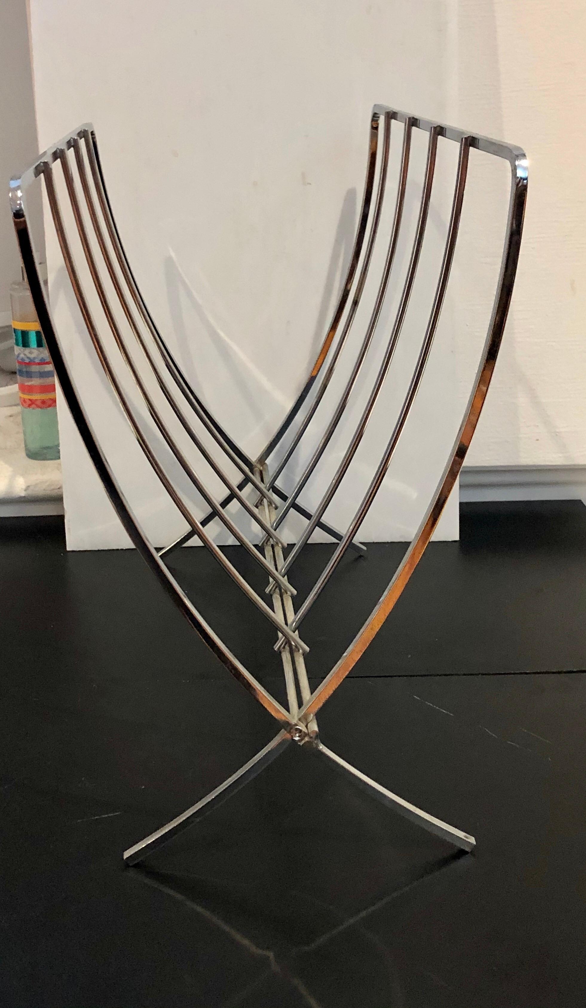 Simple elegant solid chrome metal folding magazine rack, circa 1970s, in great condition. Folds for easy storage.