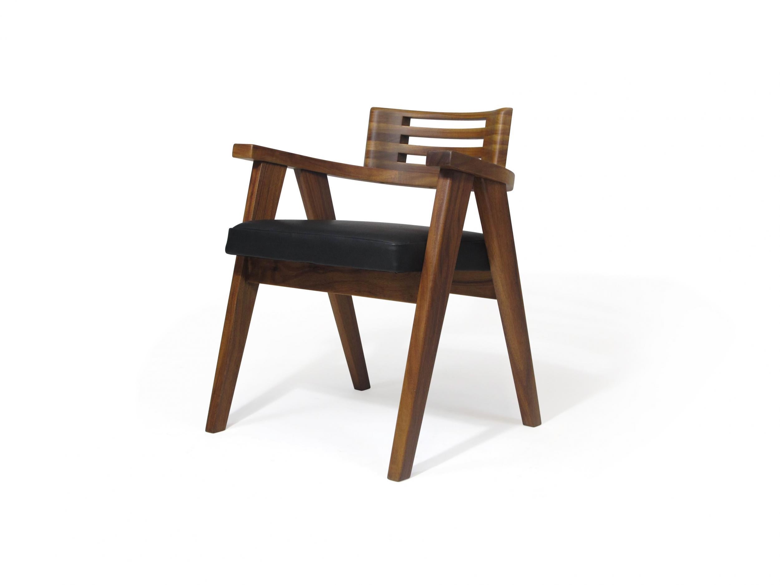 Hawaiian Koa wood dining chairs, circa 1955, hand-crafted of solid Koa, with newly upholstered seats in black leather. 
 